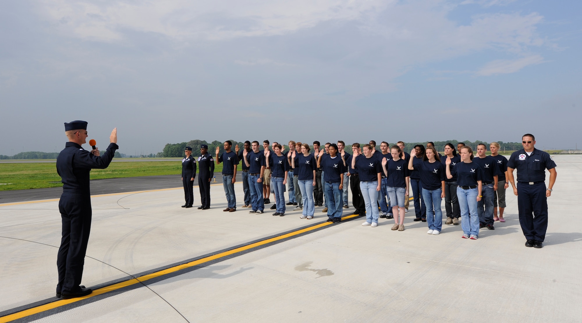 Lt. Col. Derek Routt, Thunderbirds Operations Officer, swears in a group of Air Force recruits at Dover Air Force Base June 20. The enlistment ceremony closed out the first day of the 2009 Dover AFB Open House and Air Show before thunderstorms moved over the base. (U.S. Air Force photo/Jason Minto)
