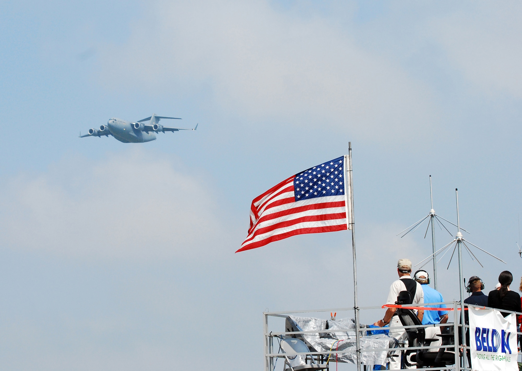 A C-17 Globemaster III flies by a group of onlookers during an aerial demonstration at the Dover Air Force Base, Del., Air Show and Open House, June 20. Despite rain and thunderstorms throughout the day, the weather broke long enough for the crowds to witness several demonstrations, including stunt flying and a F-18 Super Hornet flight. (U.S. Air Force photo/Staff Sgt. Steve Lewis)