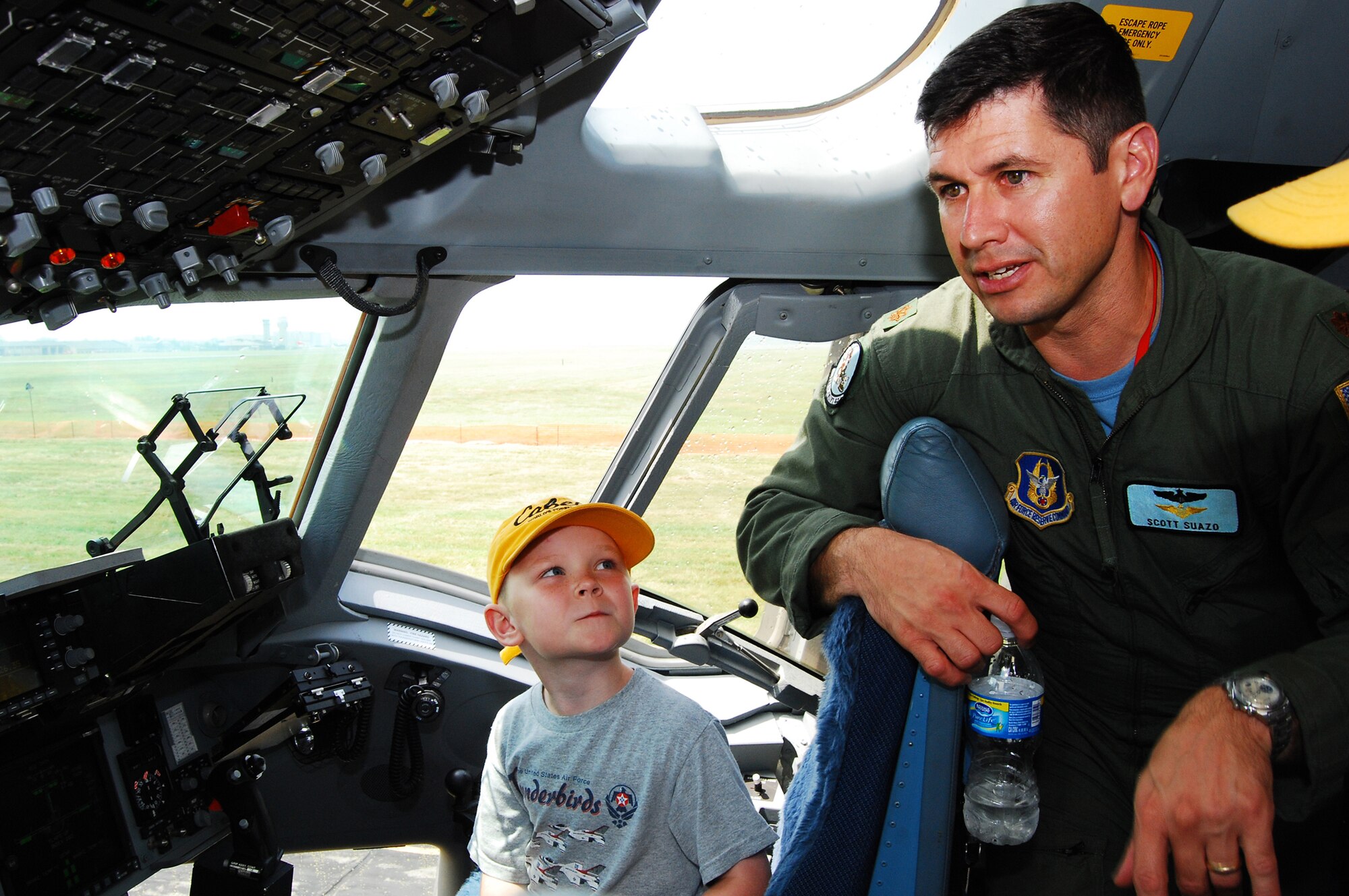 Maj. Scott Suazo, 326th Airlift Squadron pilot, explains how the controls work in the flight deck of a C-17 Globemaster III to Isaac Isabell of Gilbertsville, Pa., during Dover Air Force Base's Air Show and Open House June 20. Despite rain and thunderstorms throughout the day, the weather broke long enough for the crowds to also witness several  aerial demonstrations, including stunt flying and a F-18 Super Hornet flight. (U.S. Air Force photo/Staff Sgt. Steve Lewis)