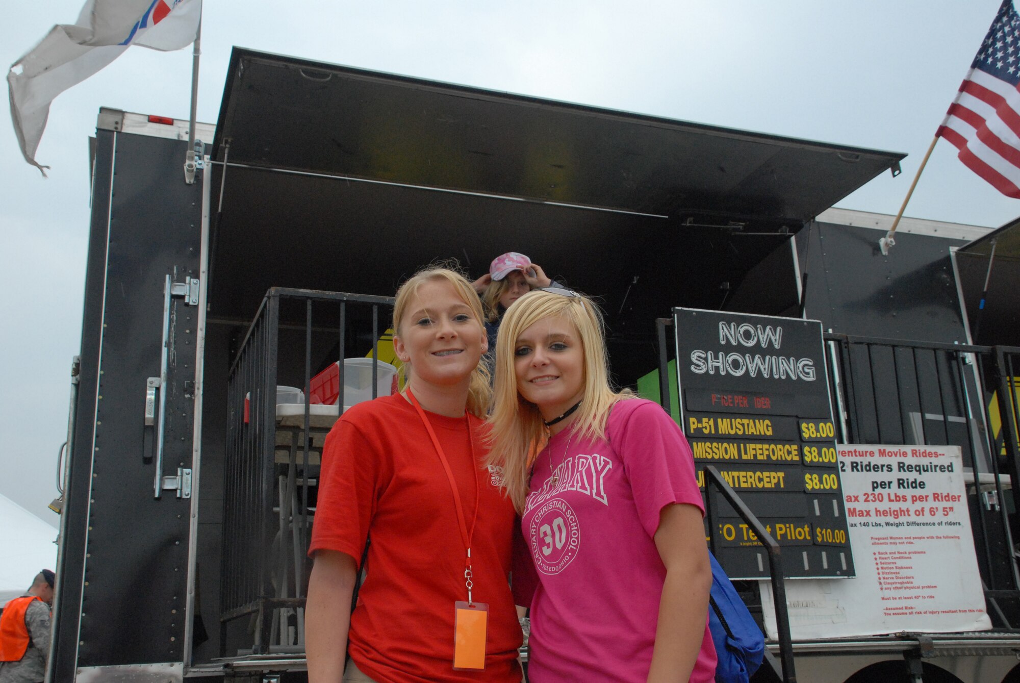 Senior Airman Krystal Miller, 436th Communications Squadron, and her sister, Katilynne Miller, wait for their turn to fly a P-51 Mustang simulator at Dover Air Force Base’s Open House and Air Show June 20. Despite inclement weather, many patrons made their way to the base for the show. (U.S. Air Force photo/Tech. Sgt. Kevin Wallace)
