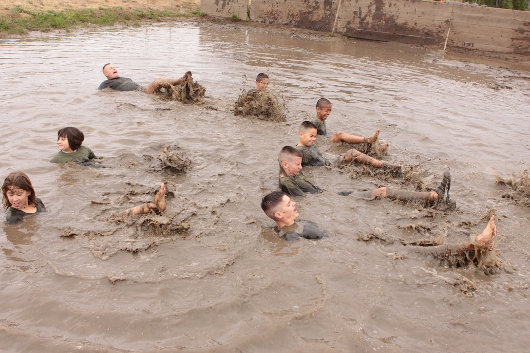 Eagle Young Marines conduct leg exercises in mud during the 3rd Annual Young Marines Mud Run, June 20. Children wanting to join the program are required to go through a form of recruit training that is conducted over eight weekends.