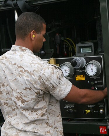 LCpl Justin Moore, MWSS-171 bulk fuel specialist, monitors the fueling of a jet on the flightline of Eielson Air Force Base, Ak, on June 19.  Moore is participating as part of Exercise Northern Edge 2009.