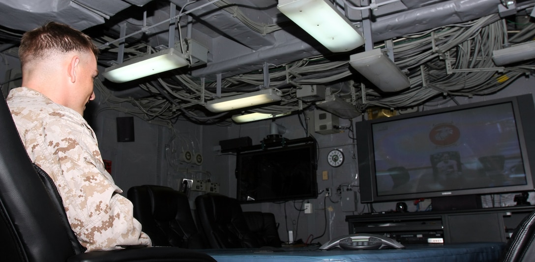 Lance Cpl. Eric Swisher, deployed aboard USS Bataan with the 22nd Marine Expeditionary Unit, talks to his wife and children who were at Camp Lejeune, N.C., via Video Tele-Conferencing link June 20, 2009. This is the first time Swisher has seen and heard his youngest son, who was born after the start of the MEU’s deployment. The 22nd MEU, embarked aboard the ships of the Bataan Amphibious Ready Group, is currently serving as the theater reserve force for U.S. Central Command.