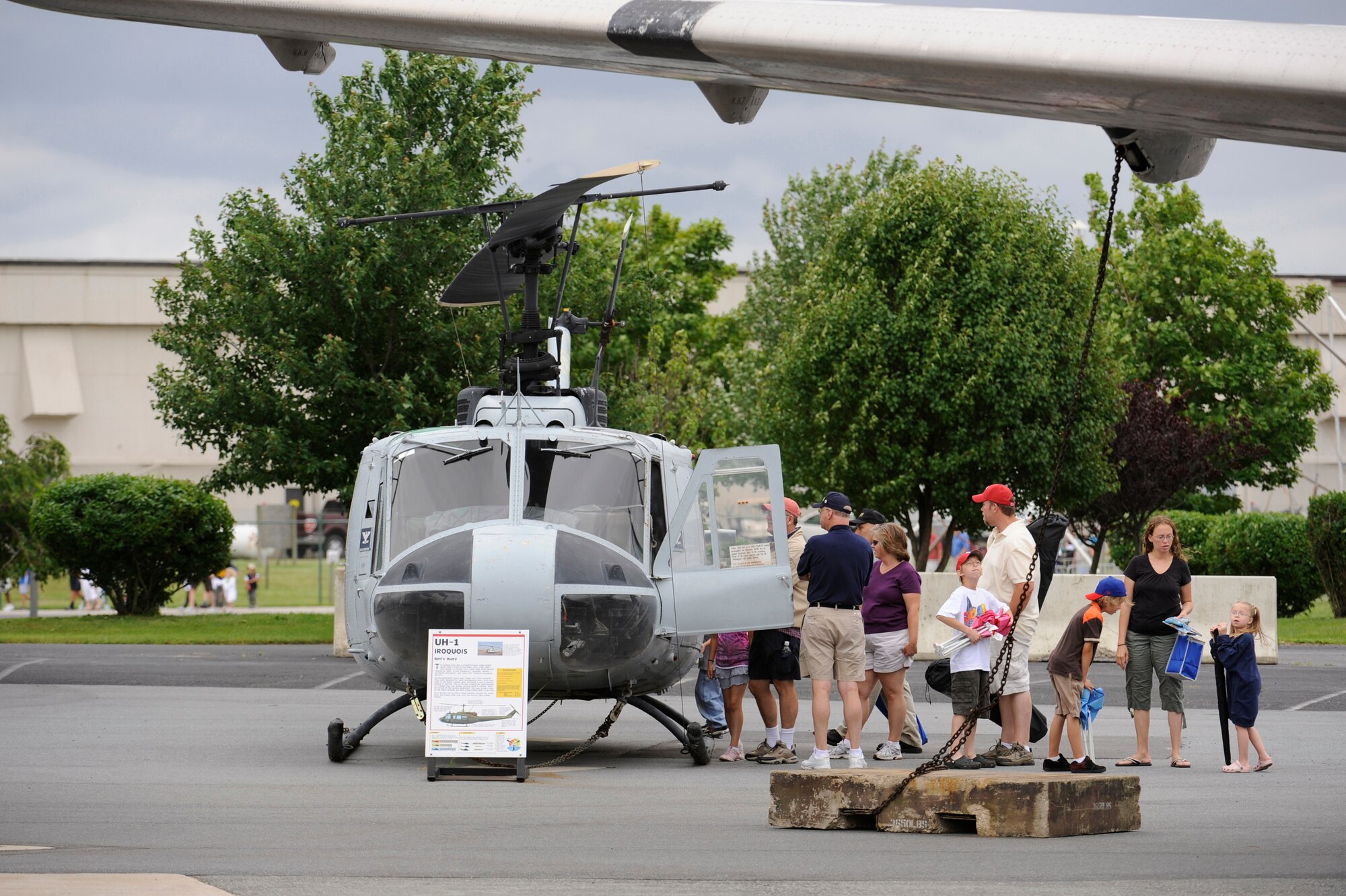 Visitors examine the UH-1 Iroquois at the Air Mobility Command Museum, one of many exhibits for Open House participants to see during Dover's Open House and Air Show June 21. (U.S. Air Force photo/Jason Minto)