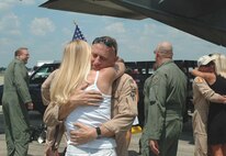 DUKE FIELD, Fla. -- Air Force Reserve Master Sgt. P.J. Walker, 711th Special Operations Squadron, receives a welcome home hug from his wife, Christy, moments after he and more than 35 of his fellow Duke Field reservists returned here June 8 from a deployment supporting Operation Enduring Freedom.  The two 919th Special Operations Wing MC-130E Combat Talon I aircraft that carried them home were also deployed for OEF, making it the largest Operation Homecoming event here in a year.  (U.S. Air Force photo/Dan Neely)