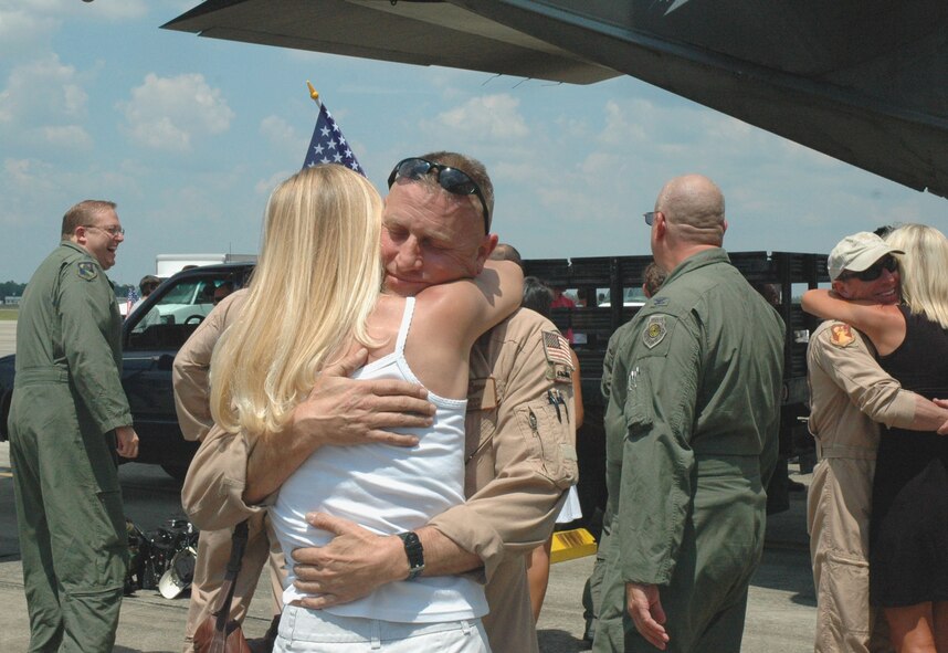 DUKE FIELD, Fla. -- Air Force Reserve Master Sgt. P.J. Walker, 711th Special Operations Squadron, receives a welcome home hug from his wife, Christy, moments after he and more than 35 of his fellow Duke Field reservists returned here June 8 from a deployment supporting Operation Enduring Freedom.  The two 919th Special Operations Wing MC-130E Combat Talon I aircraft that carried them home were also deployed for OEF, making it the largest Operation Homecoming event here in a year.  (U.S. Air Force photo/Dan Neely)