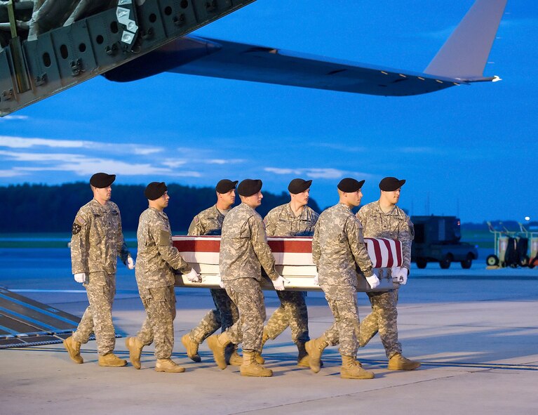 An Army carry team transfers the remains of Army Spc. Chancellor A. Keesling, of Indianapolis, Ind., at Dover Air Force Base, Del., June 20. Specialist Keesling was assigned to the 961st Engineer Company, Sharonville, Ohio, U.S. Army Reserve. (U.S. Air Force Photo/Jason Minto)
