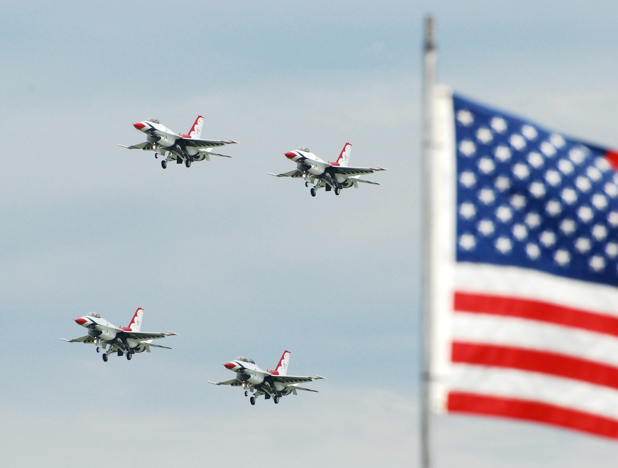 U.S. Air Force Thunderbirds soar past the crowd in a low flying manuever during the 2009 Dover Air Force Base Open House and Air Show. The Thunderbirds were one of many flying acts that took place at the weekend event. (U.S. Air Force photo/Staff Sgt. Steve Lewis)