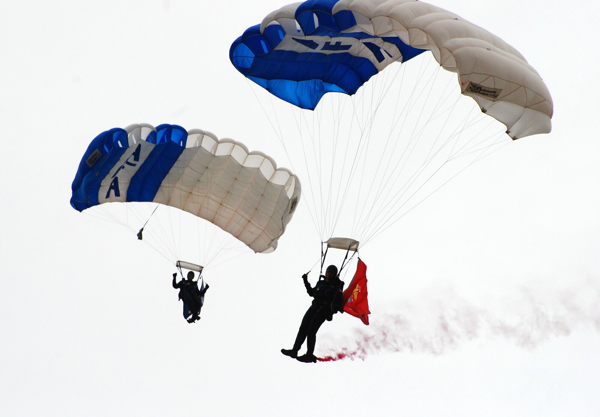 U.S. Air Force Academy Wings of Blue parachutists give off a trail of colored smoke as they make their way toward land during the 2009 Dover Air Force Base Open House and Air Show June 21. The parachutists were among several aerial demonstrations held during the weekend event. (U.S. Air Force photo/Staff Sgt. Steve Lewis)