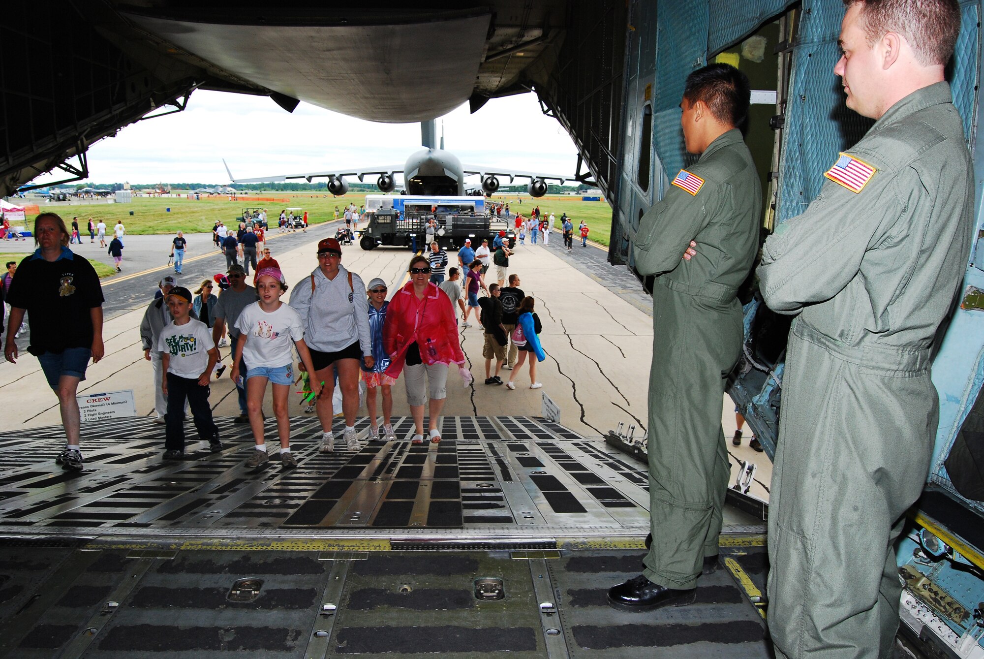 C-5 Galaxy loadmasters from the 709th Airlift Squadron ensure attendees safely enter their aircraft during the 2009 Dover Air Force Base Open House and Air Show June 21. The C-5 was one of several static displays being showcased at the weekend event, which also included a C-17 Globemaster III, KC-10 Extender and KC-135 Stratotanker.(U.S. Air Force photo/Staff Sgt. Steve Lewis)