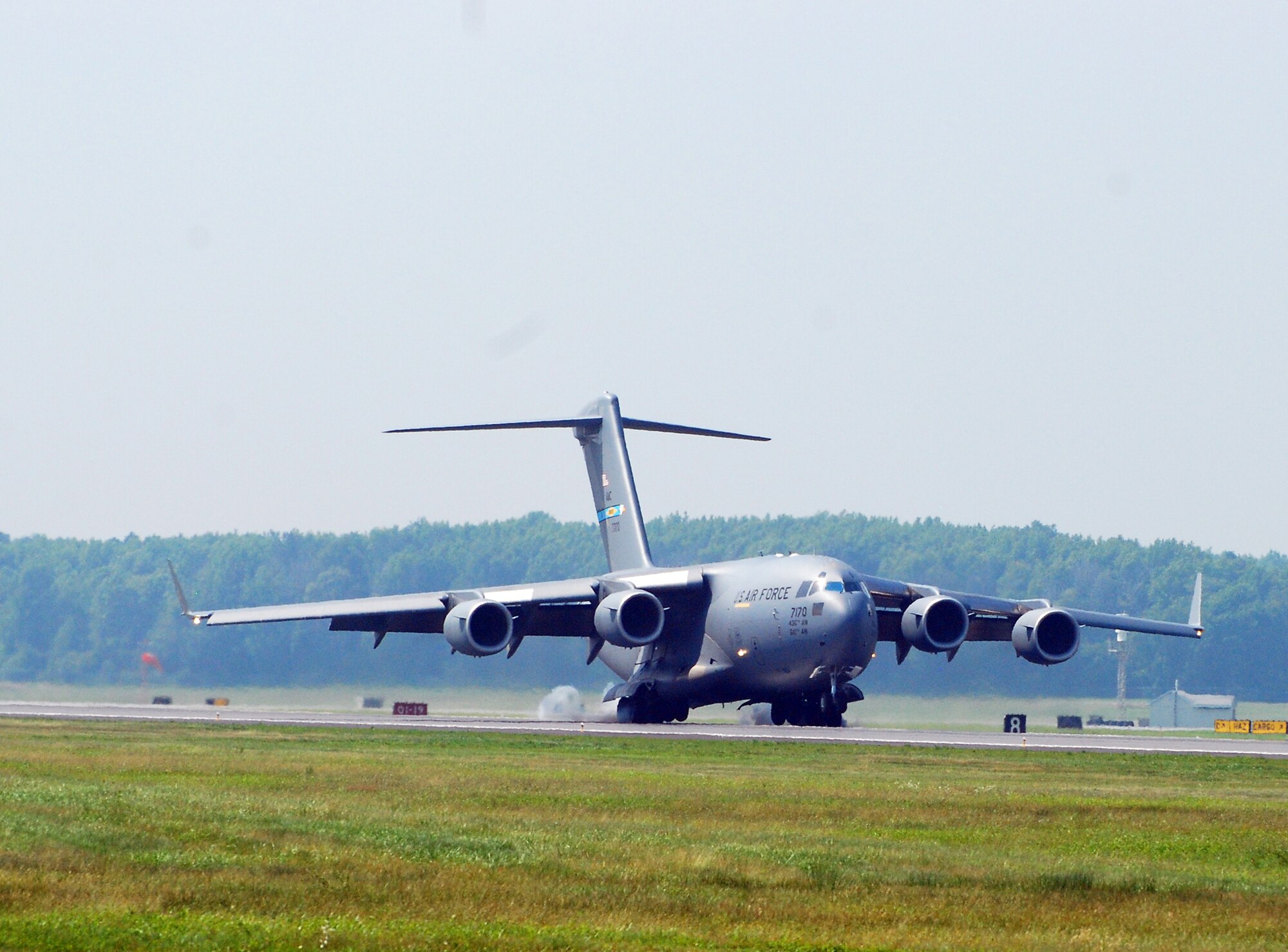 A C-17 Globemaster III touches down on the runway during an aerial demonstration at the 2009 Dover Air Force Base Open House and Air Show June 20. The C-17 flight was one of several aircraft demonstrations including an acrobatic stunt flying and a Thunderbird finale. (U.S. Air Force photo/Staff Sgt. Steve Lewis)