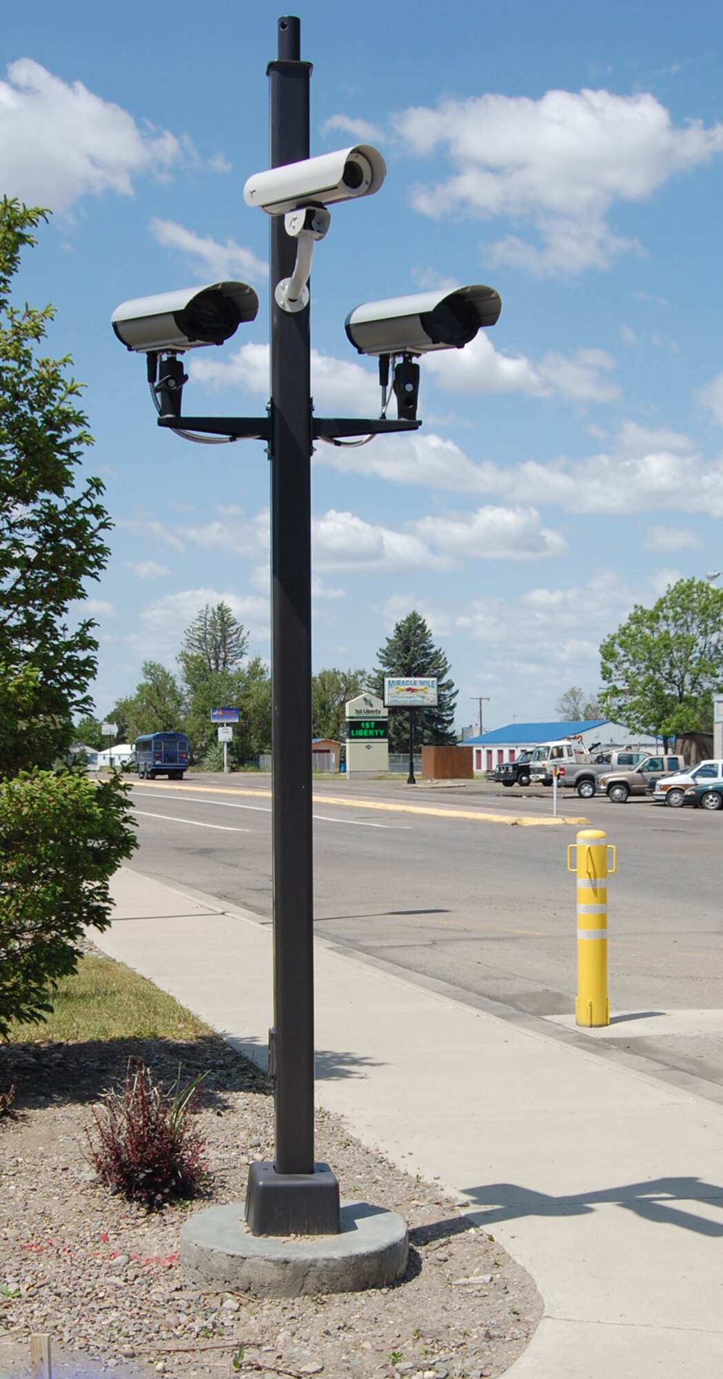 Two cameras and a closed circuit TV are mounted on a fixed concrete base aimed at the main gate. The equipment is part of the new License Plate Recognition System recently installed at both gates at Malmstrom. (U.S. Air Force photo/Valerie Mullett)