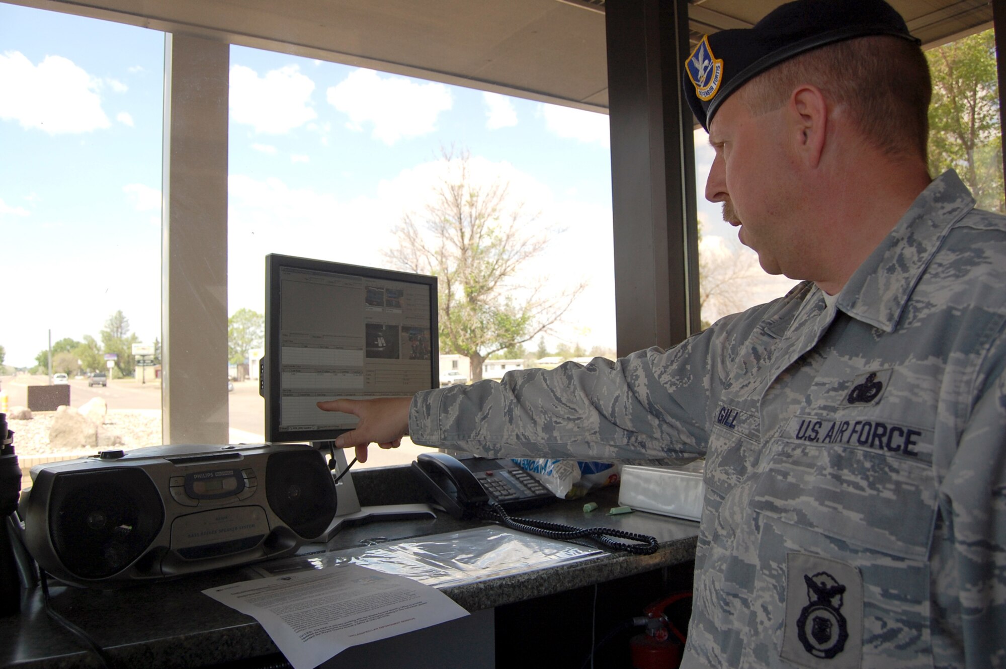 Master Sgt. Gary Gill, NCOIC of Installation Security, points to the area on the computer screen where information would populate if a vehicle photographed had an unfavorable history. (U.S. Air Force photo/Valerie Mullett)