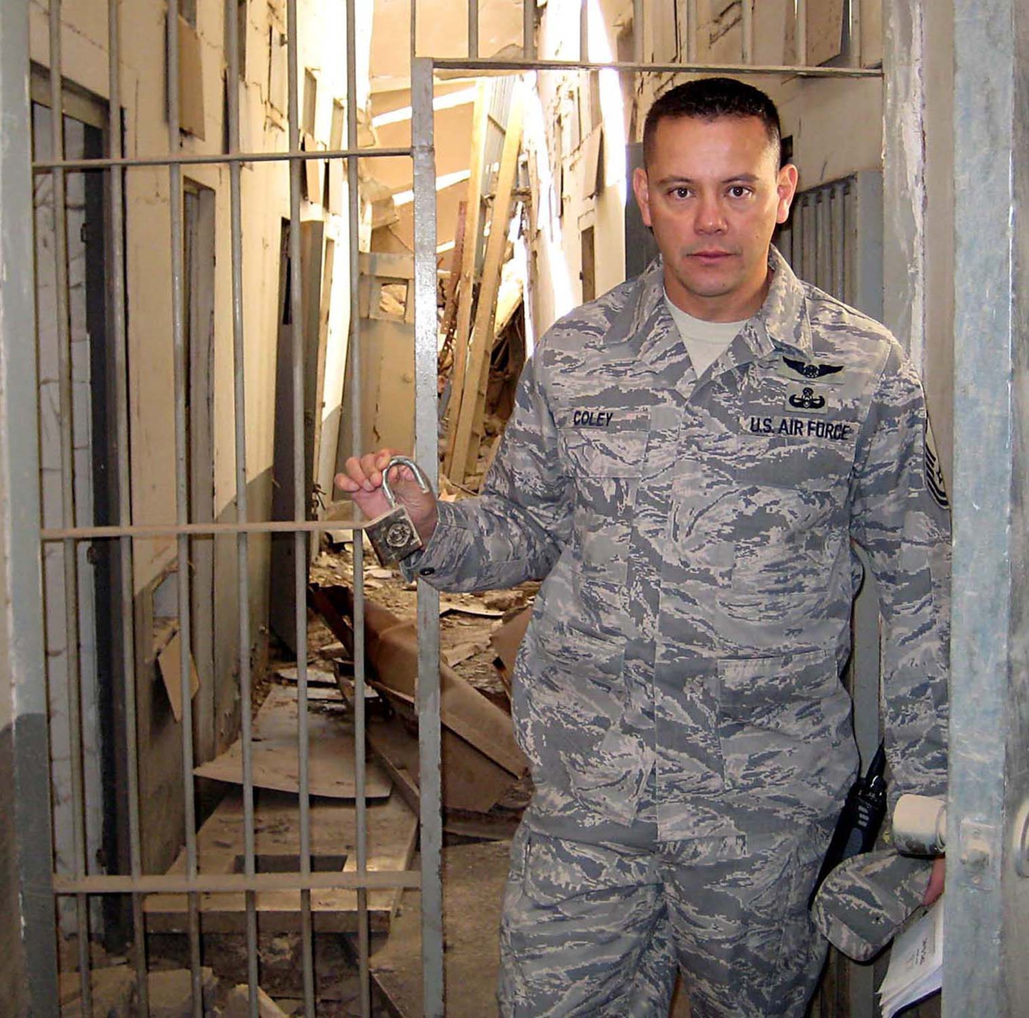 A relatively undisturbed lock in a bombed out prison in Southwest Aisa is held by Senior Master Sgt. James Coley, 446th Civil Engineer Squadron explosive ordnance disposal, McChord Air Force Base, Wash. Sergeant Coley earned the Bronze Star for his service while deployed Iraq. (Courtesy photo/Senior Master Sgt. James Coley)