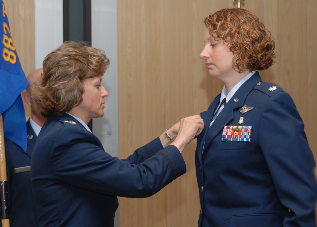 Col. Nancy Dezell, 882nd Training Group commander, pins the commander’s pin on Lt. Col. Jennifer Kimmet, incoming 383rd Training Squadron commander, June 22 during a change of command ceremony. Colonel Kimmet replaced Lt. Col. Robie Hughes. (U.S. Air Force photo/ Lou Anne Sledge)
