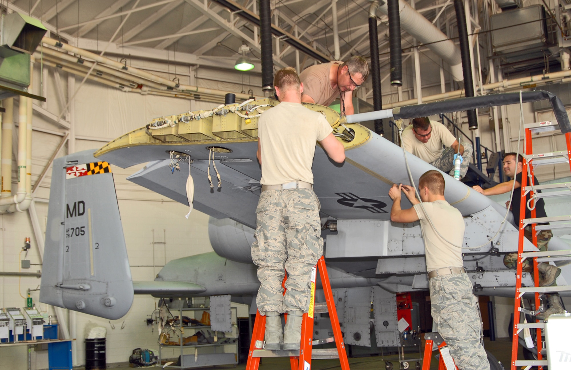 A team of Idaho Air National Guard maintainers from the 124th Wing at Gowen Field in Boise, Idaho reinstall the leading edges on the wing of a Maryland Air National Guard A-10 Thunderbolt II. The aircraft received a new AAR-47 infrared missile warning system as part of the A-10 Consolidated Install Program June 16. (U.S. Air Force photo/Master Sgt. Thomas Gloeckle) 
