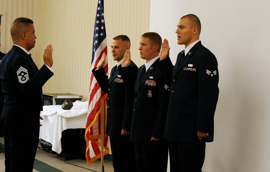 MOODY AIR FORCE BASE, Ga. -- Chief Master Sgt. Paul Burgess, 23rd Wing command chief, gives the noncommissioned officer oath to senior airmen making the transition to staff sergeant during an Airman Leadership School graduation here May 21. The mission of ALS is to prepare senior airmen to assume supervisory duties, to teach communication skills and to foster a commitment to the profession of arms.  (U.S. Air Force photo by Airman 1st Class Joshua Green)