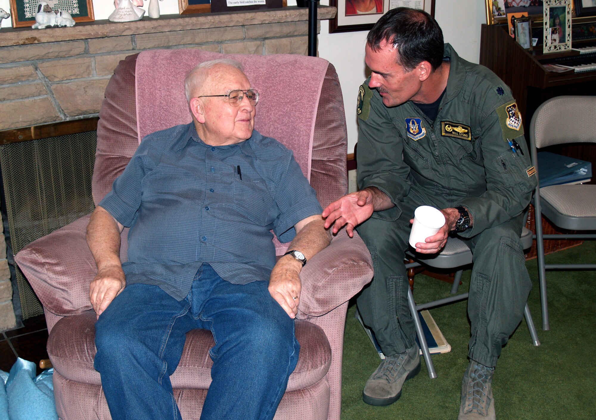 Lt. Col. Bill Lyons, 419th Operations Group commander, discusses changes in the nature of war and aviation with Grant Harris, a former Navy fighter pilot who served in World War II. Colonel Lyons joined Harris, who is battling leukemia, at his home in Spanish Fork, Utah, June 17. (U.S. Air Force photo/Bryan Magaña)