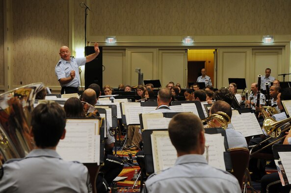 Col. Dennis M. Layendecker, United States Air Force Band commander, conducts a concert June 19 at the Arlington Ballroom of the Crystal Gateway Marriott in Arlington, Va. The concert featured the Concert Band and Singing Sergeants along with select student musicians, and guest emcee Florence Henderson. Each of the Band’s performing ensembles presents outdoor concerts as part of their Summer Concert Series for National Capitol Region residents, as well as visitors from around the world, at the United States Air Force Memorial on Wednesdays and Fridays throughout the summer. This performance was moved indoors due to inclement weather. To stay in tune of the Band’s schedule, visit http://www.usafband.af.mil/. (U.S. Air Force photo by Senior Airman Marleah Miller)
