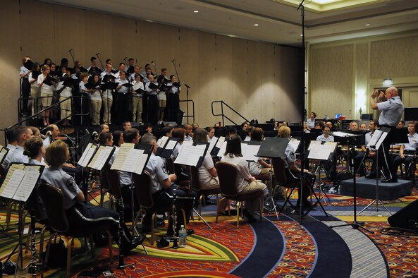 The U.S. Air Force Band and Singing Sergeants perform with select student musicians as part of the Music Educators National Conference Music Education Week in Washington during a concert June 19 at the Arlington Ballroom of the Crystal Gateway Marriott in Arlington, Va. The concert featured the Concert Band and Singing Sergeants along with select student musicians, and guest emcee Florence Henderson. Each of the Band’s performing ensembles presents outdoor concerts as part of their Summer Concert Series for National Capitol Region residents and visitors at the United States Air Force Memorial on Wednesdays and Fridays throughout the summer. (U.S. Air Force photo by Senior Airman Marleah Miller) 