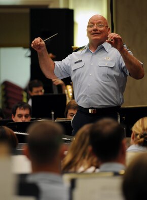 Col. Dennis M. Layendecker, U.S. Air Force Band commander, conducts the Band during a concert June 19 at the Arlington Ballroom of the Crystal Gateway Marriott in Arlington, Va. The United States Air Force Memorial is where the Band usually plays on Wednesdays and Fridays throughout the summer, but this performance was moved indoors due to weather. (U.S. Air Force photo by Senior Airman Marleah Miller)