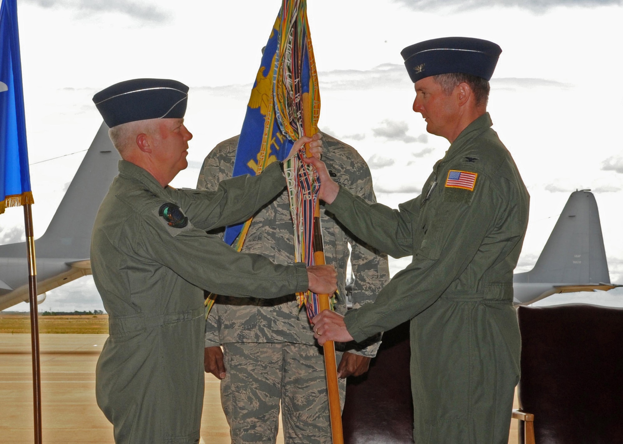 CANNON AFB, N.M.-- Lt. Gen. Donald C. Wurster (left), commander, Air Force Special Operations Command, presents Col. Stephen A. Clark, 27th Special Operations Wing commander, the squadron flag to the 16th Special Operations Squadron here June 19. The flag-transfer ceremony marked the official transfer of the squadron from Hurlburt Field, Fla., to Cannon Air Force Base. (U.S. Air Force photo by Staff Sgt. Heather R. Redman/RELEASED)