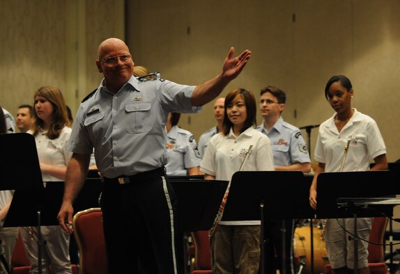 Col. Dennis M. Layendecker, U.S. Air Force Band commander, introduces the concert band and young artists from the Music Educators National Conference Music Education Week in Washington during a concert June 19. The concert featured the Concert Band and Singing Sergeants along with select student musicians, and guest emcee Florence Henderson. Each of the Band’s performing ensembles presents outdoor concerts as part of their Summer Concert Series for National Capitol Region residents, as well as visitors from around the world, at the United States Air Force Memorial on Wednesdays and Fridays throughout the summer. For more information, visit http://www.usafband.af.mil/.  (U.S. Air Force photo by Senior Airman Marleah Miller)