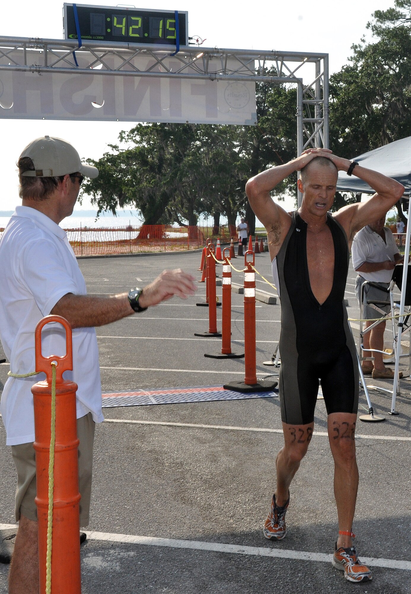 EGLIN AIR FORCE BASE, Fla. --  Scott Ewing of Destin crosses the finish line placing third in 42:11 at the 10th Annual My First Tri triathlon at Post’l Point June 20. The triathlon featured a 200-meter swim, 8-mile bike ride and 2.5-mile run. Wendy Ewing finished first in the overall women’s division with a time of 47:57. 1st Lt. Scott Eberle, 86th Fighter Wing Squadron (49:50) and Colleen Riddle (53:40) finished first in the first timers division. 122 first timers and 132 alumni participated in this year’s event.  (U.S. Air Force photo/ Airman Anthony Jennings) 
