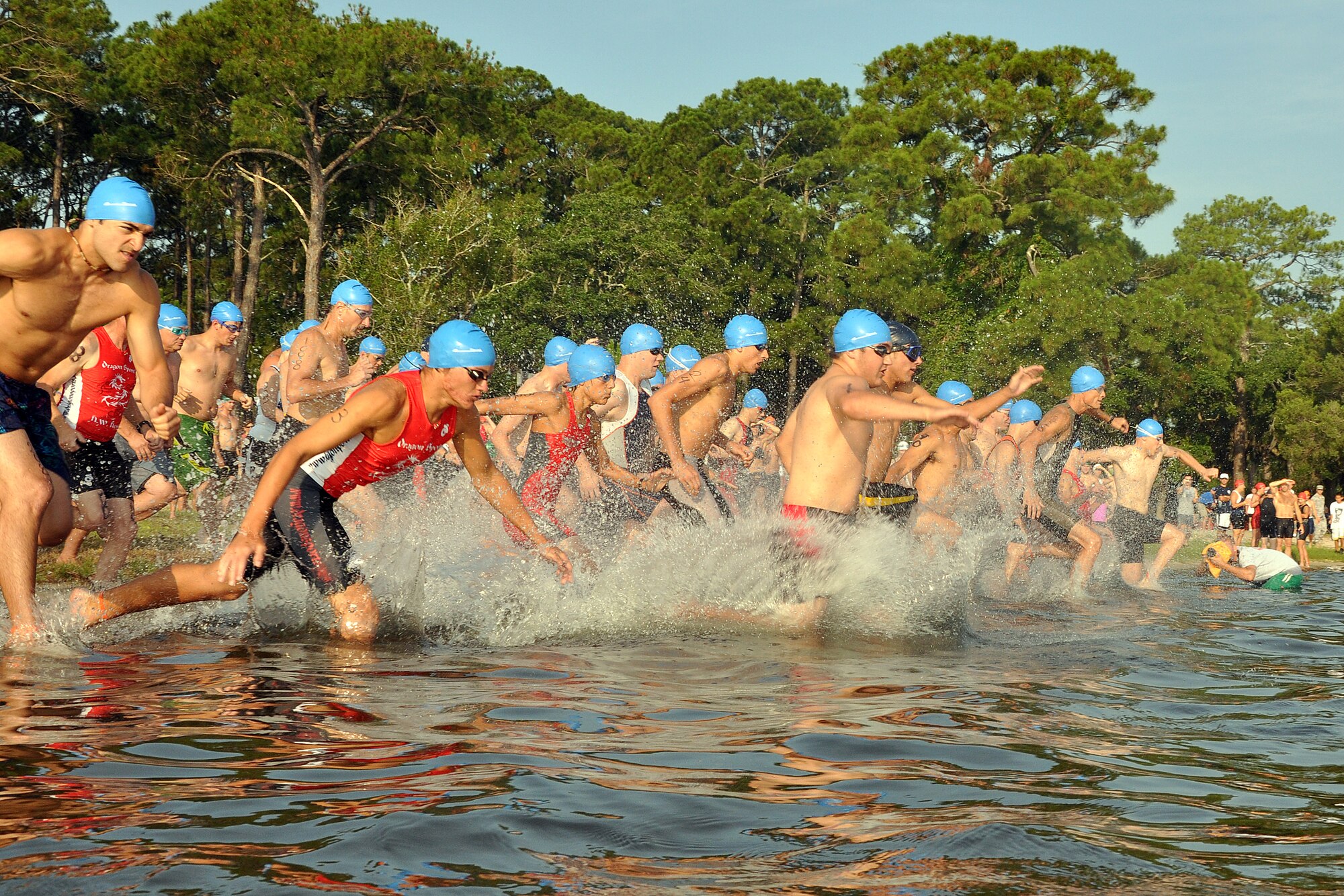 EGLIN AIR FORCE BASE, Fla. –  The first wave of tri-athletes splash into the water at the 10th Annual My First Tri triathlon at Post’l Point June 20.  The triathlon featured a 200-meter swim, 8-mile bike ride and 2.5-mile run. 122 first timers and 132 alumni participated in this year’s event. (U.S. Air Force photo/ Airman Anthony Jennings)
