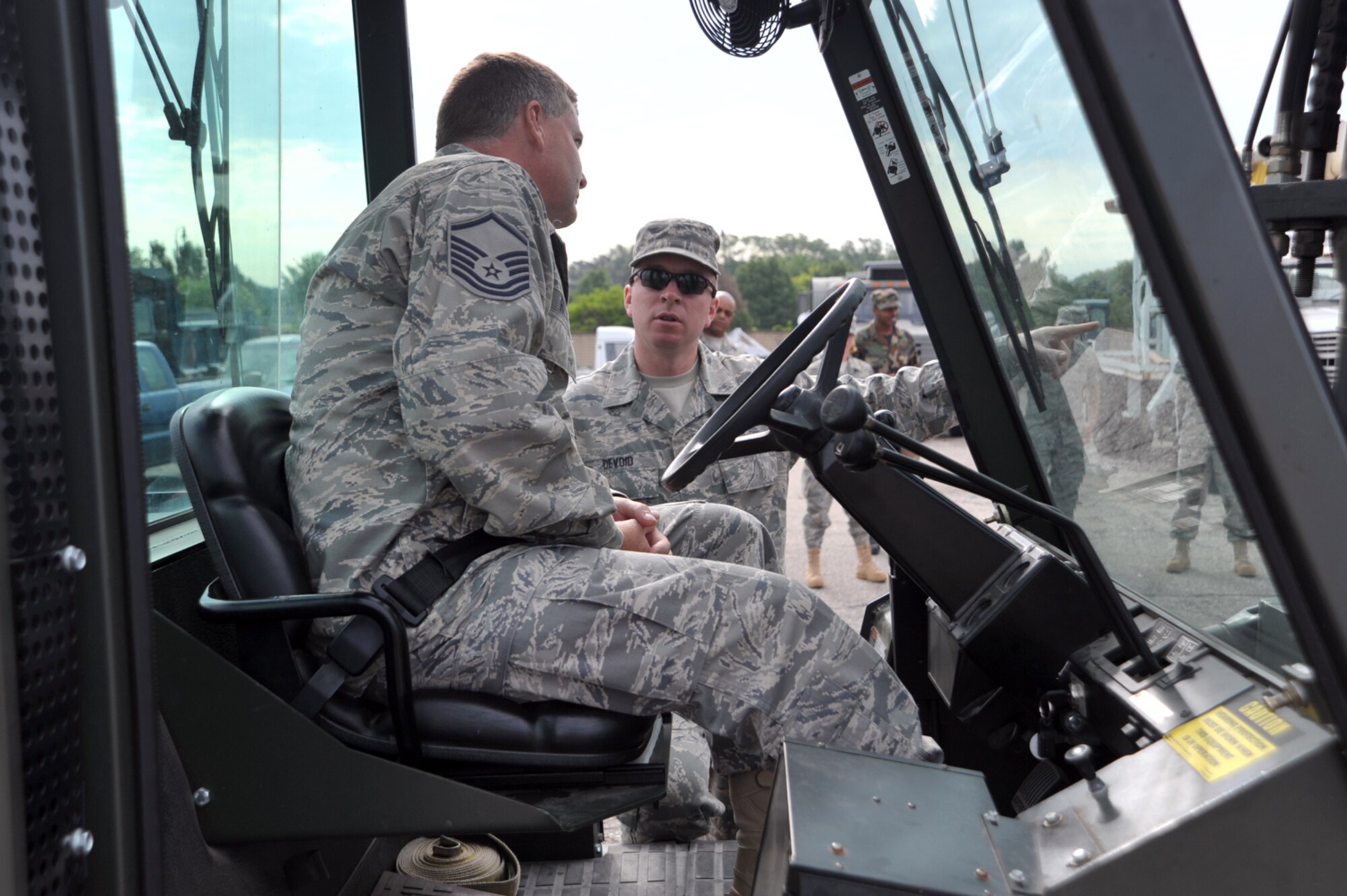 Tech. Sgt. Christopher Devoid offers some instruction to Master. Sgt. Leo Ritter while training with a forklift during the 931st Air Refueling Group's drill weekend in June. Both sergeants are assigned to the 931st Civil Engineer Squadron, an Air Force Reserve unit at McConnell Air Force Base, Kan. (U.S. Air Force photo/Tech. Sgt. Jason Schaap)