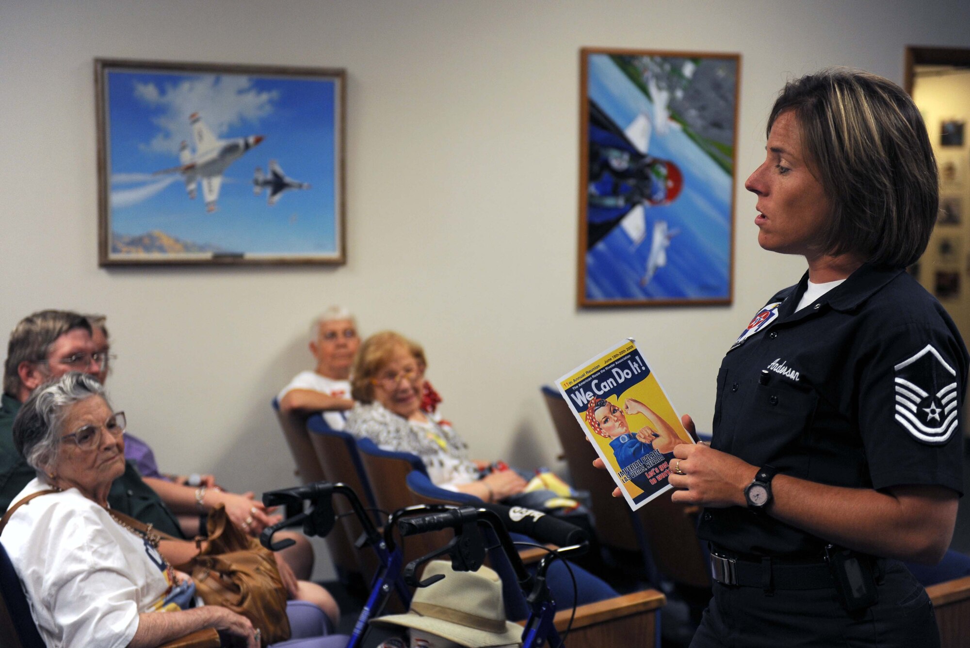 Master Sgt. Pamela Anderson, United States Air Force Air Demonstration Squadron "Thunderbirds" public affairs superintendent, briefs members of the American Rosie the Riveter Association about Thunderbird history at Nellis Air Force Base, Nev., June 19. Rosie the Riveter is a cultural icon of the United States, representing the American women who worked in war factories and assumed job positions in the places of male workers who were in the military during World War II. (U.S. Air Force Photo/Senior Airman Larry E. Reid Jr.)