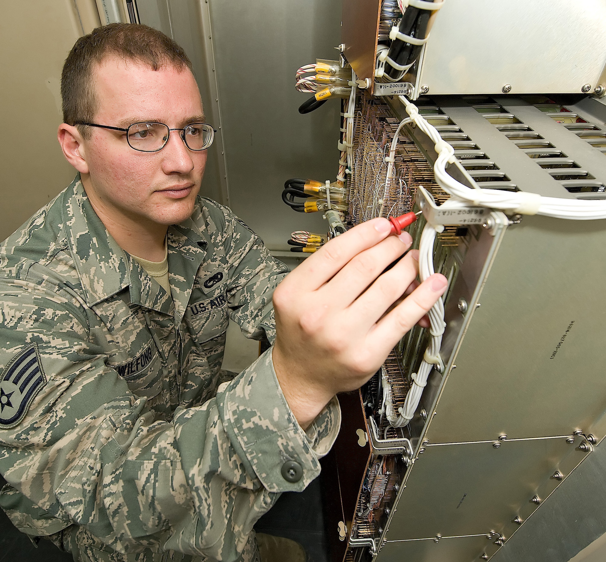 Staff Sgt. Josh Wilfong, 436th Communications Squadron ground radar systems technician, uses an instrument to check for electricity, called the digital multi-meter, which checks the accuracy of voltages inside the shelter of the Airport Surveillance Radar. (Air Force photo/ Jason Minto)