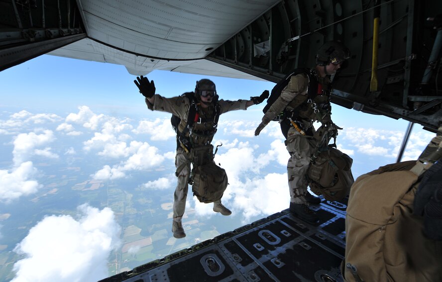MOODY AIR FORCE BASE, Ga. -- From left, Staff Sgt. David Schumacher and Airman 1st Class Christopher Bailey, 38th Rescue Squadron pararescuemen, step off the edge of a HC-130P King cargo bay door here June 19. The Airmen were performing the jumps to stay current on qualifications.  (U.S. Air Force photo by Staff Sgt. Javier Cruz Jr.)