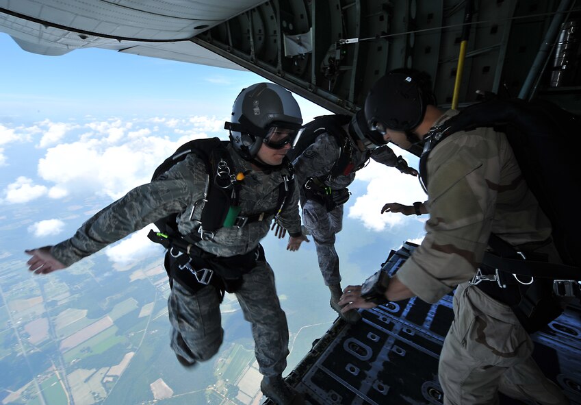 MOODY AIR FORCE BASE, Ga. -- Airmen from the 93rd Air Ground Operations Wing and the 38th Rescue Squadron push off the edge of a HC-130P King cargo door here June 19. Approximately 19 Airmen completed successful jumps over the Moody flightline.  (U.S. Air Force photo by Staff Sgt. Javier Cruz Jr.)