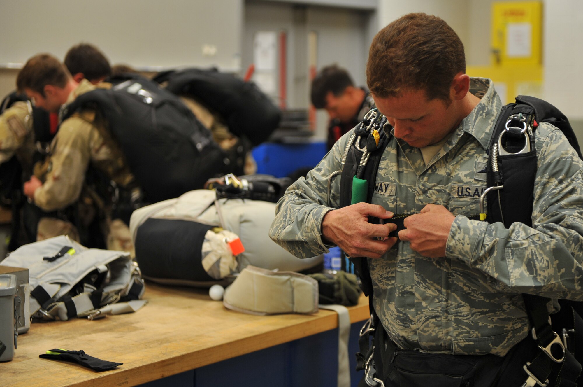 MOODY AIR FORCE BASE, Ga. -- Tech. Sgt. Robert Callaway, 93rd Air Ground Operations Wing tactical air control party (TACP), secures his parachute straps during a preflight equipment inspection here June 19. Sergeant Callaway, along with 38th Rescue Squadron pararescuemen, completed three successful jumps.  (U.S. Air Force photo by Staff Sgt. Javier Cruz Jr.)