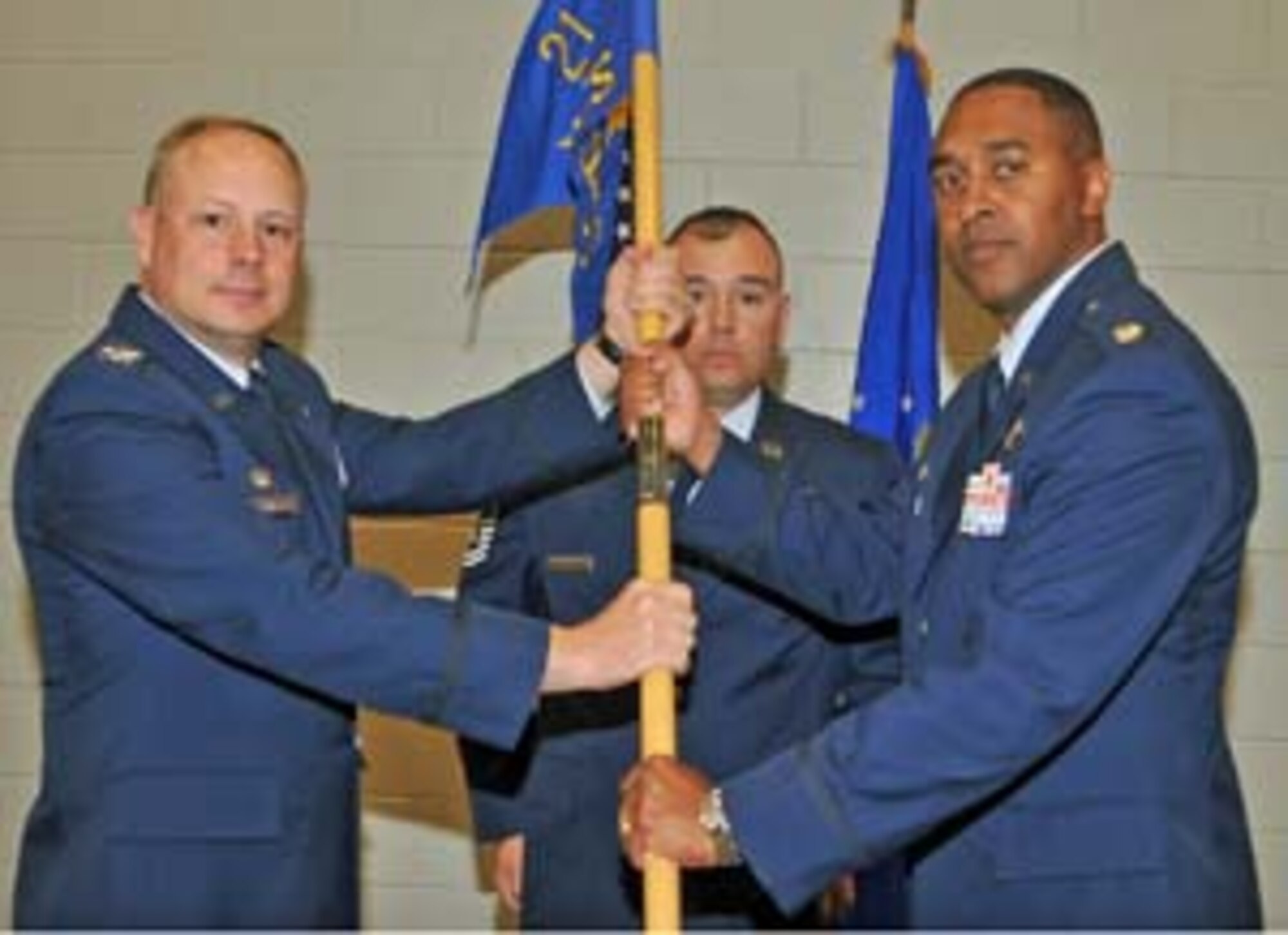 PETERSON AIR FORCE BASE, Colo.--Lt. Col. Elvert Gardener (right) assumes command of the 76th Space Control Squadron in a ceremony June 8 at Building 2028. Col. Chris Crawford (left), 21st Operations Group commander, passes the squadron’s guidon to Colonel Gardner. Lt. Col. Jennifer Moore relinquished 76th SPCS command during the ceremony. Prior to his assignment as the 76th SPCS commander, Colonel Gardner served as the chief of the Space Superiority Programming Branch at Headquarters Air Force Space Command's Plans, Programs and Analysis Directorate. Colonel Moore's next assignment is deputy commander of the 595th Operations Group at Schriever Air Force Base, Colo. (U.S. Air Force photo)
