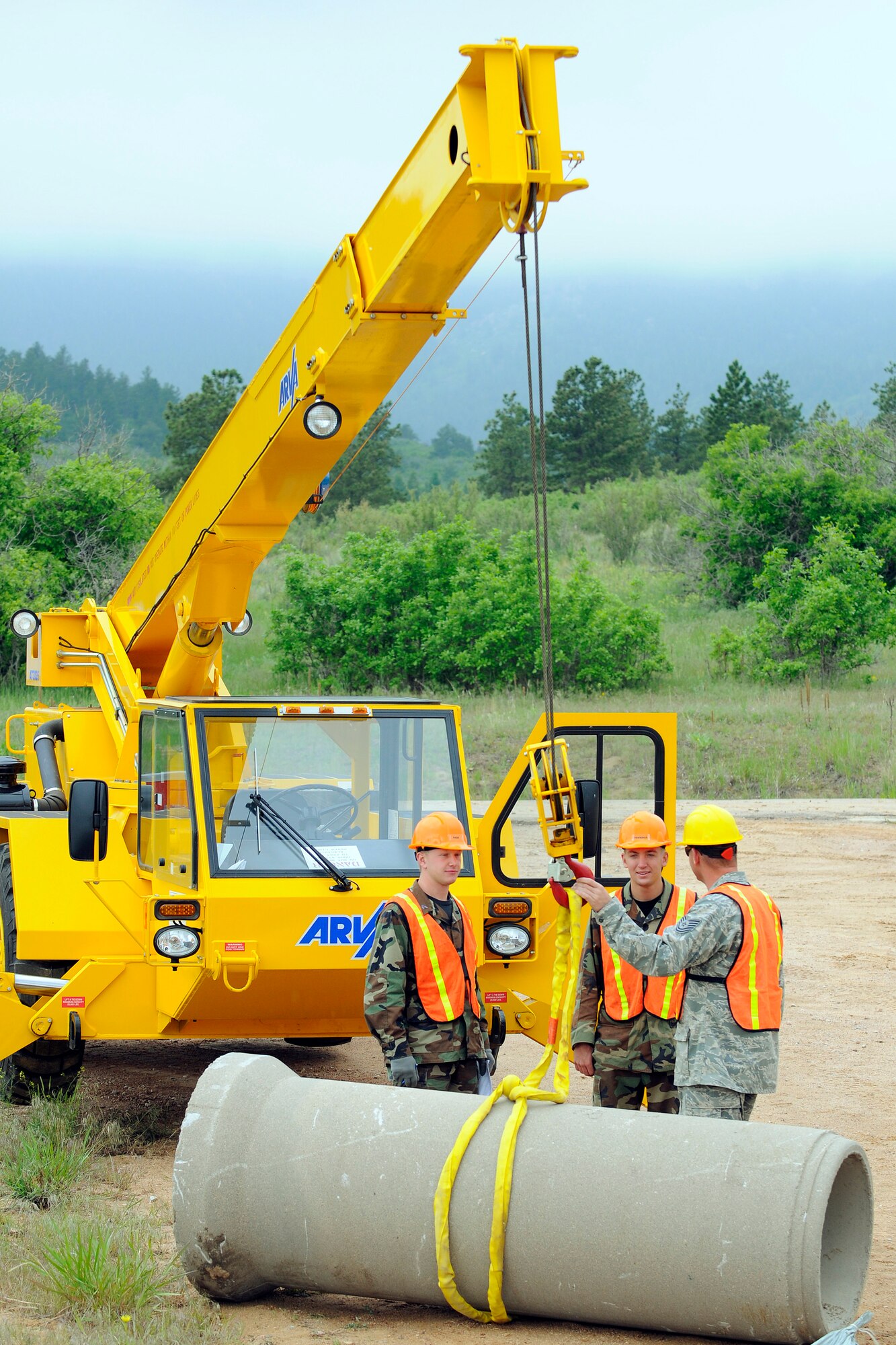 Cadets 2nd Class Will Page and Marc Penninga listen to instruction on hoisting a 7.5-ton train during a heavy equipment activity. Instructing them was Tech. Sgt. Bobby Wilkins from the 460th Civil Engineer Squadron at Buckley Air Force Base, Colo. (U.S. Air Force photo/Dave Ahlschwede)
