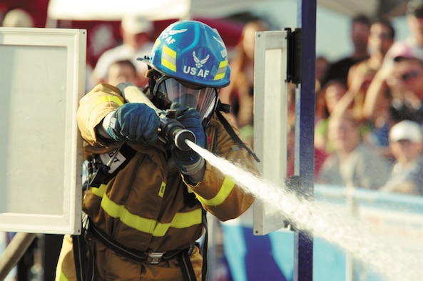 U.S. Air Force Academy firefighter Patrick Kraft shows off his hose technique Aug. 11, 2006, during the 2006 Firefighter Combat Challenge regional competition in Westminster, Colo.Kraft will compete with Team USAFA in 2009 after strong finishes in World Firefighter Combat Challenges in 2006, 2007 and 2008. The 2009 challenge is open to the public and will be held at the Air Force Academy. (U.S. Air Force photo/John Van Winkle)