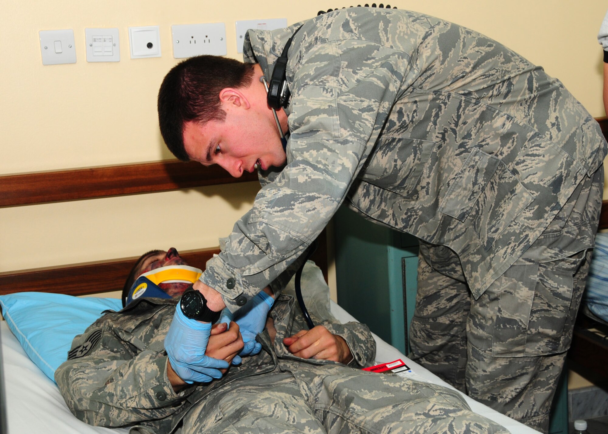 SOUTHWEST ASIA -- Capt. Donald Euler, 386th Expeditionary Medical Group ground critical care team chief, checks the severity of burns a simulated patient received during a dorm fire exercise at an air base in Southwest Asia, June 22. Depending on the location affected and the degree of severity, a burn victim may experience a wide number of potentially fatal complications including shock, infection, electrolyte imbalance and respiratory distress.  Captain Euler is deployed from Wright-Patterson Air Force Base, Ohio, and hails from Chattanooga, Tenn. (U.S. Air Force photo/Senior Airman Courtney Richardson)