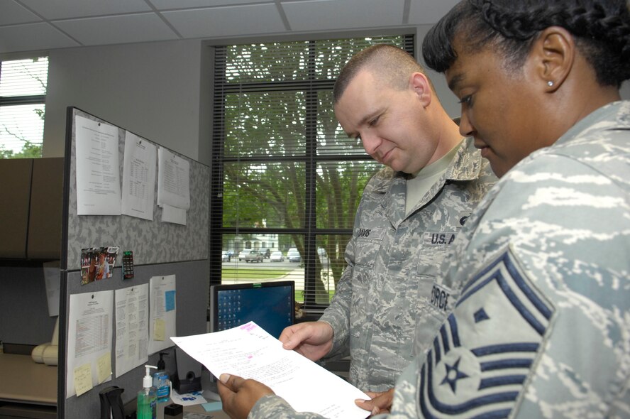 BARKSDALE AIR FORCE BASE, La. -- Senior Master Sergeant Riley, 8th Air Force (Air Forces Strategic) first sergeant, addresses Staff Sgt. Davis during her work center visitation, June 10. Since first sergeants are heavily involved with base activities, opportunities to meet base personnel are plentiful. They are able to interact with not only individuals who they are helping, but also leadership, which many consider to be benefits to the job.(U.S. Air Force photo by Airman 1st Class Allison M. Boehm)