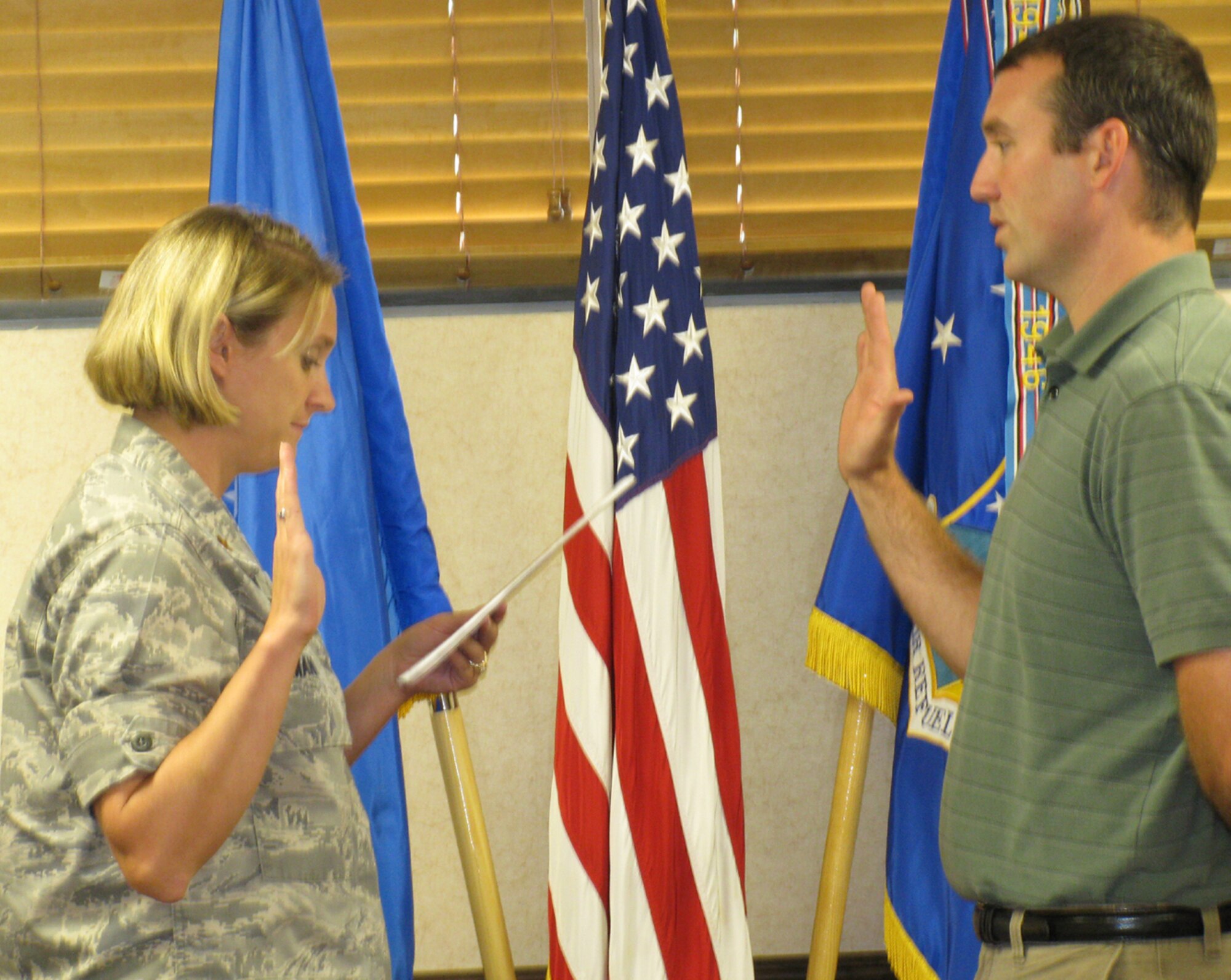 SEYMOUR JOHNSON AIR FORCE BASE, N.C. -- Terry Toner (right) is sworn in to the Air Force Reserve on June 17 at the 916th Air Refueling Wing. Toner will be a metals technician with the 567th RED HORSE Squadron and is the son of Senior Master Sgt. Judy Toner of the 916th Communication Squadron. (U.S. Air Force photo by: Senior Master Sgt. Judy Toner)