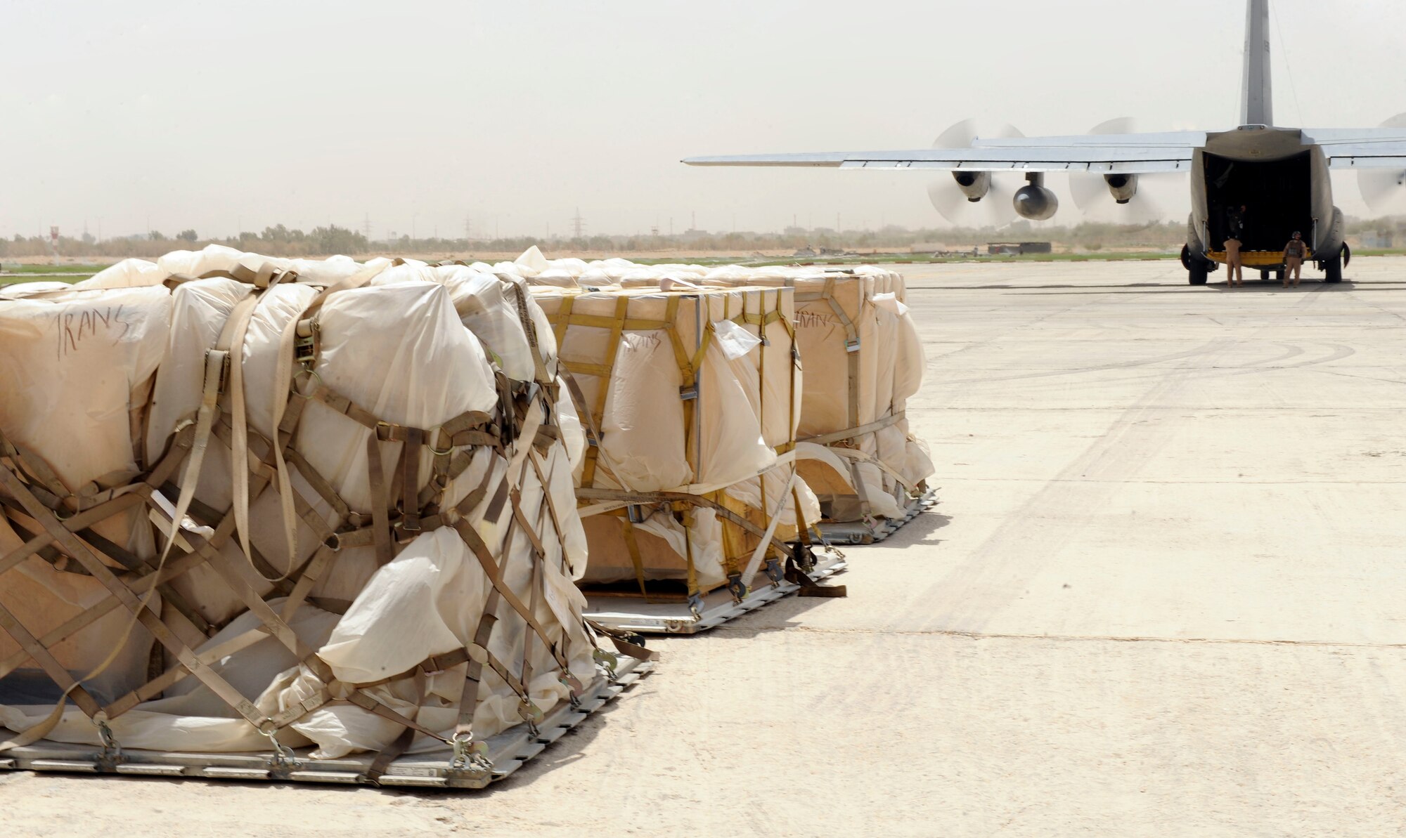 Three pallets of humanitarian aid awaits for pickup, transportation and delivery at Najaf, Iraq June 21, 2009. The flight was scheduled to drop off the aid and donated supplies to displaced families at Camp Al-Manathera.  (U.S. Air Force photo by Senior Airman Jacqueline Romero) 