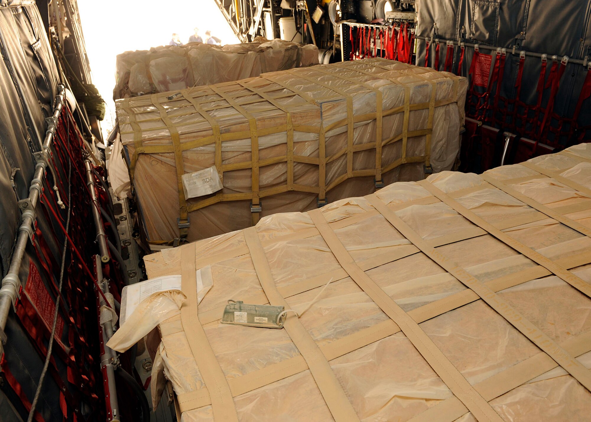 Three pallets of humanitarian aid awaits for pickup, transportation and delivery at Najaf, Iraq June 21, 2009. The flight was scheduled to drop off the aid and donated supplies to displaced families at Camp Al-Manathera.  (U.S. Air Force photo by Senior Airman Jacqueline Romero) 