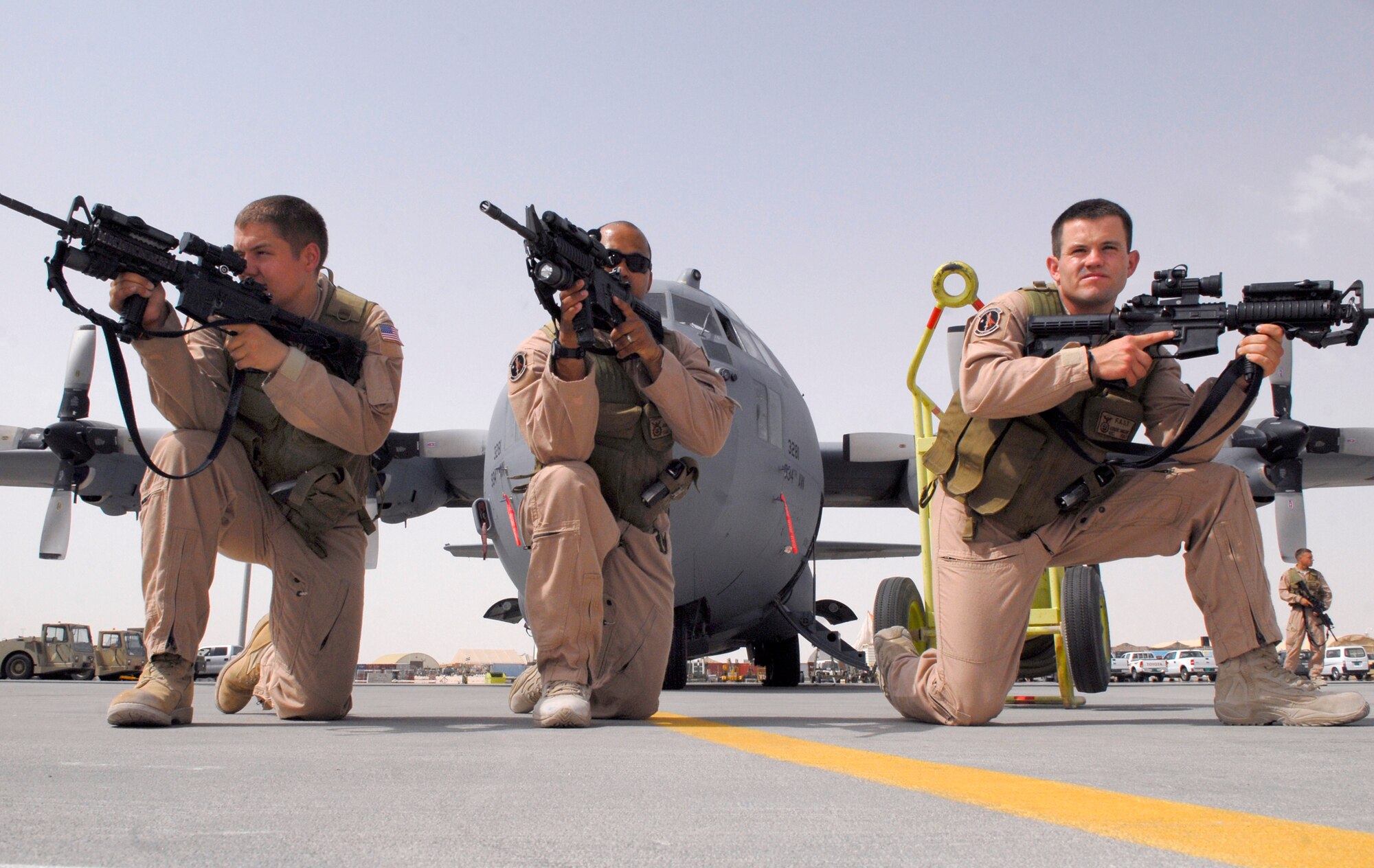 Airman 1st Class Corey Davis, 379th Expeditionary Security Forces Squadron (ESFS) Fly away team (FAST) member, Staff Sgt. James Booker, 379th ESFS FAST leader, and Airman 1st Class Robert Hansen, 379th ESFS FAST member, post up in the front of a C-130 during a training exercise, June 18, 2009, at an undisclosed location in Southwest Asia.    The FAST team provides security for all airlift assets operating in the U.S. Central Command's area of responsibility, where additional security is needed at unsecure locations.  Airman Davis hails from Bremen, Ga. and is deployed from Eielson Air Force Base, Alaska.  Sergeant Booker hails from San Antonio, Texas and is deployed from Eielson Air Force Base, Alaska.  Airman Hansen hails from Mesa, Ariz. and is deployed from Tyndall Air Force Base, Fla.  All are deployed in support of Operations Iraqi and Enduring Freedom and Combined Joint Task Force - Horn of Africa.  (U.S. Air Force photo/Senior Airman Andrew Satran/released)