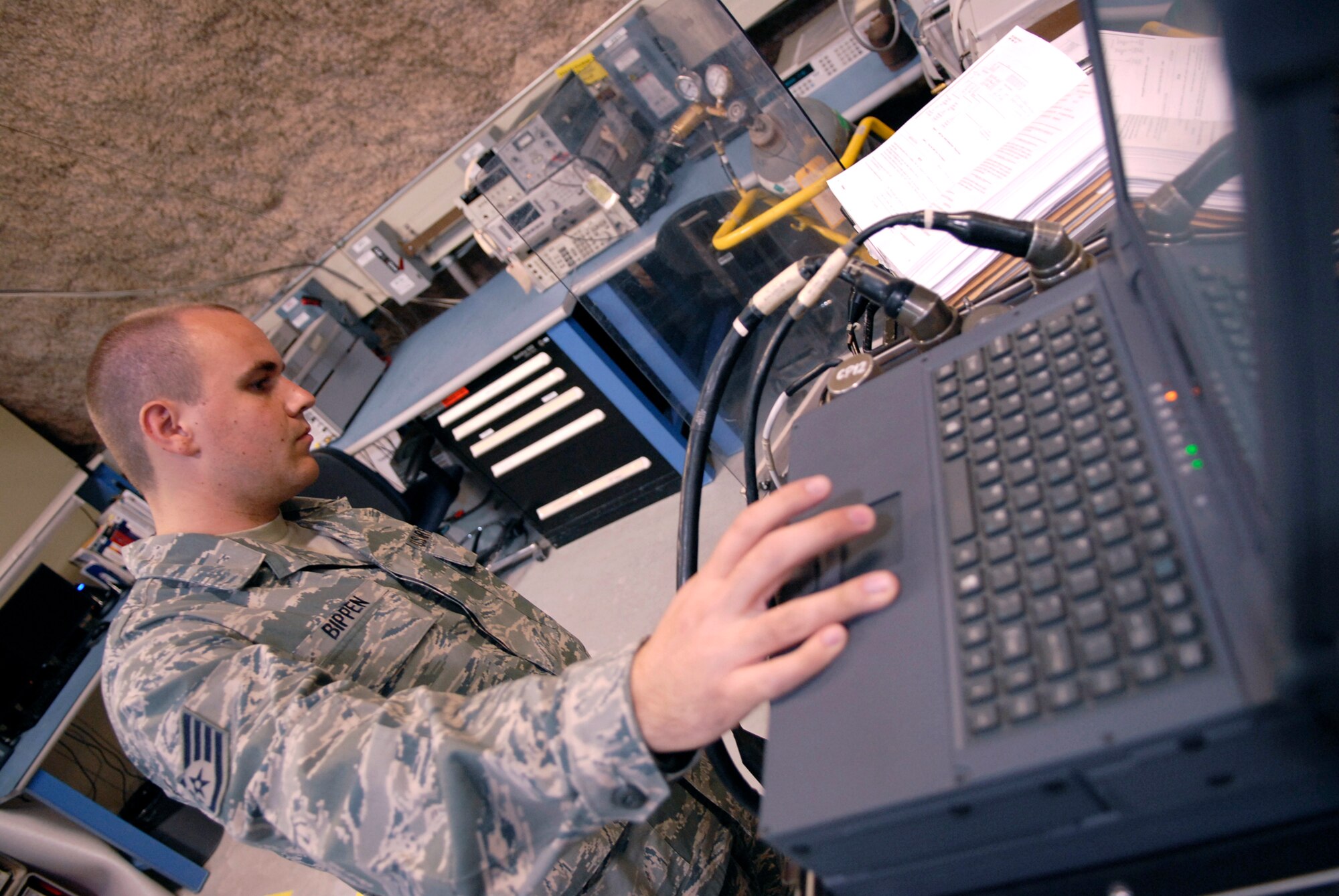 Staff Sgt. Ryan Bippen, a 379th Expeditionary Maintenance Squadron Precision Measurement Equipment Laborartory technician, runs the self test calibration for a weapon guidance system, June 15, 2009, at an undisclosed location in Southwest Asia.  Sergeant Bippen ensures the equipment can run its own tests before he begins to run calibrations.  Sergeant Bippen hails from San Francisco, Calif. and is deployed from Mountain Home Air Force Base, Idaho, in support of Operations Iraqi and Enduring Freedom and Combined Joint Task Force - Horn of Africa.  (U.S. Air Force photo/Senior Airman Andrew Satran/released)