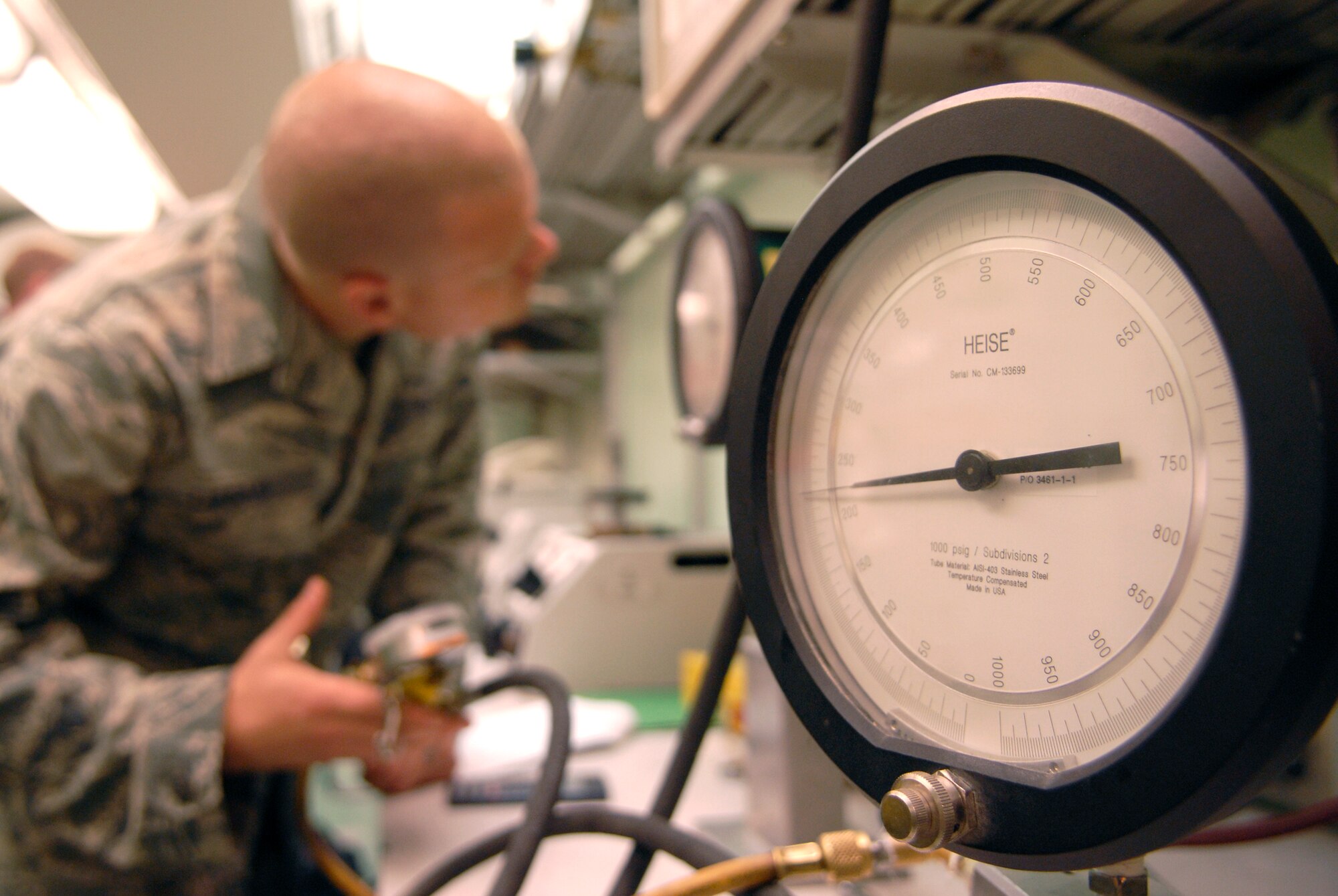 Staff Sgt. Mason Lucas, 379th Expeditionary Maintenance Squadron test measurement diagnostic equipment craftsman, uses a pressure gauge to check a tire inflator's relief valve, June 15, 2009, at an undisclosed location in Southwest Asia.  The tire inflator will be used in a forward operating location in the U.S. Central Command's area of responsibility.  The Airmen who work in the Precision Measurement Equipment Laboratory (PMEL) calibrate and test equipment critical to mission accomplishment.  Sergeant Lucas hails from Purcellville, Va. and is deployed from Langley Air Force Base, Va., in support of Operations Iraqi and Enduring Freedom and Combined Joint Task Force - Horn of Africa.  (U.S. Air Force photo/Senior Airman Andrew Satran/released)