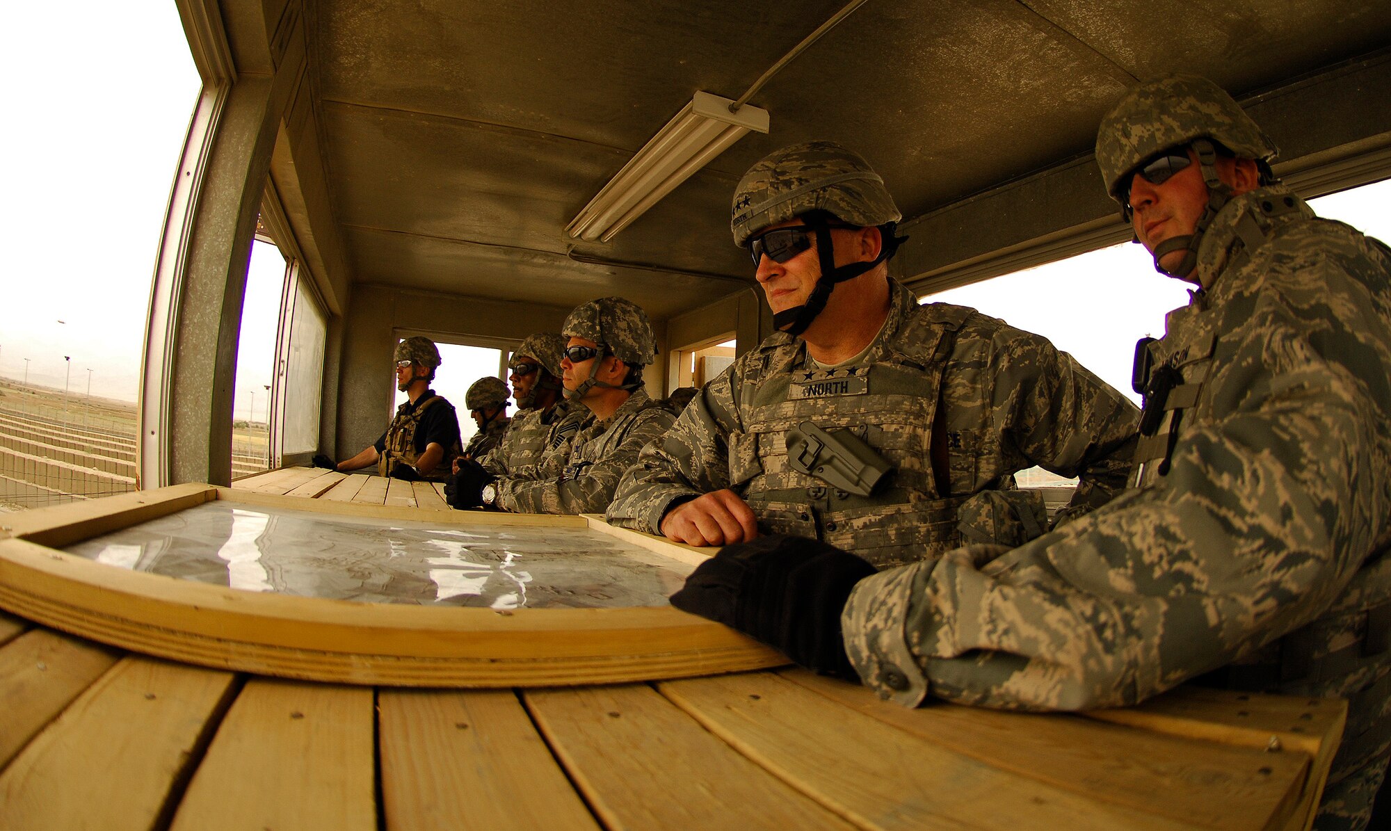 BAGRAM AIR FIELD, Afghanistan - Capt. Ron Johnson, 455th Expeditionary Security Forces Squadron, Lt. Gen. Gary North, U.S. Air Forces Central and 9th Air Force commander, and Col. Steven Kwast, 455th Air Expeditionary Wing commander, survey the horizon while visiting one of Bagram Air Field's guard towers June 16. General North visited and spoke with hundreds of Airmen as he prepares for his final month as commander after serving more than three years. (Air Force/Staff Sgt. Jason Lake)