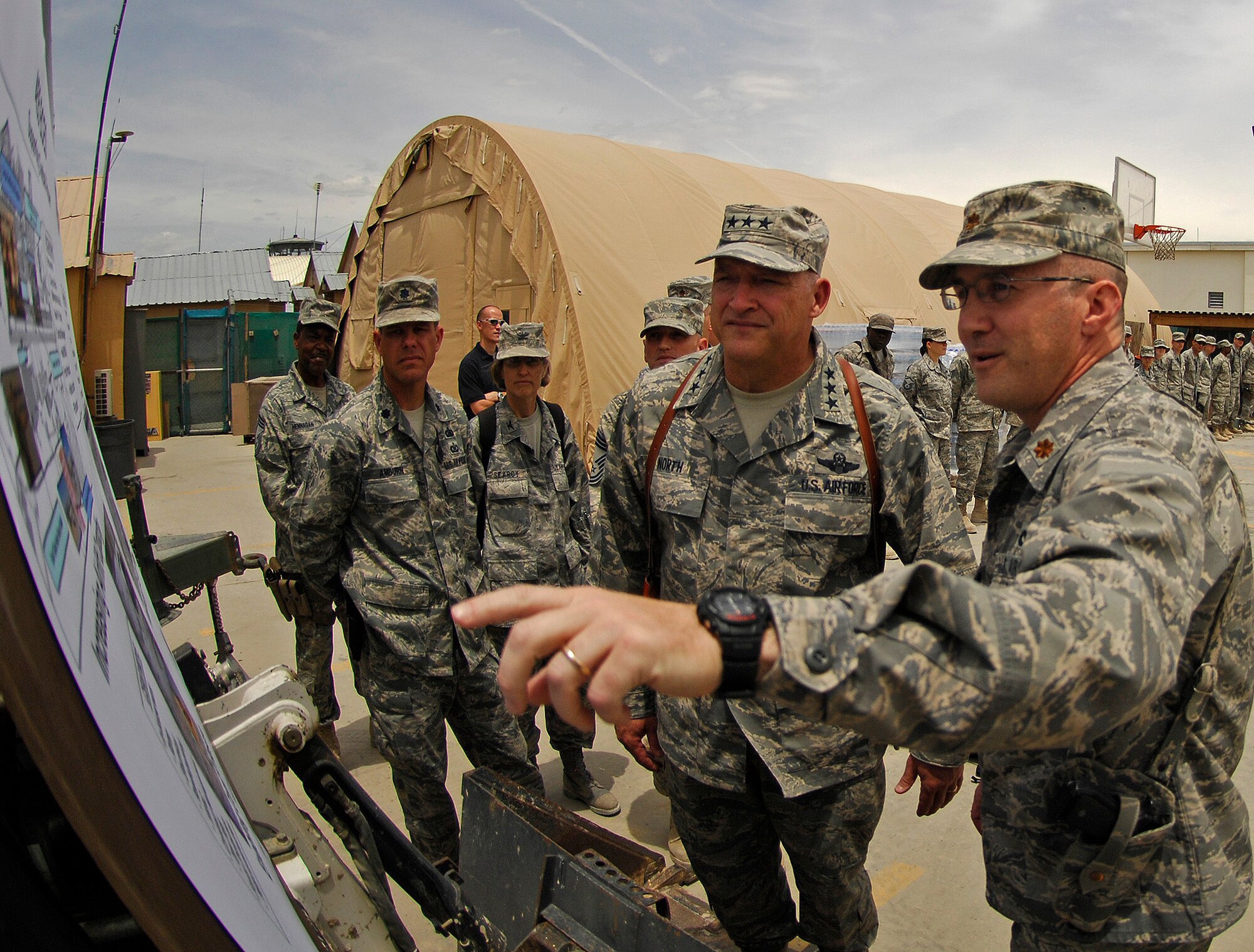 BAGRAM AIR FIELD, Afghanistan - Maj. Brian Stahl, 455th Expeditionary Civil Engineer Squadron commander, briefs Lt. Gen. Gary North, U.S. Air Forces Central and 9th Air Force commander, on current and future construction projects at Bagram Air Field, Afghanistan, June 16.  General North visited and spoke with hundreds of Airmen as he prepares for his final month as commander after serving more than three years. (Air Force/Staff Sgt. Jason Lake)