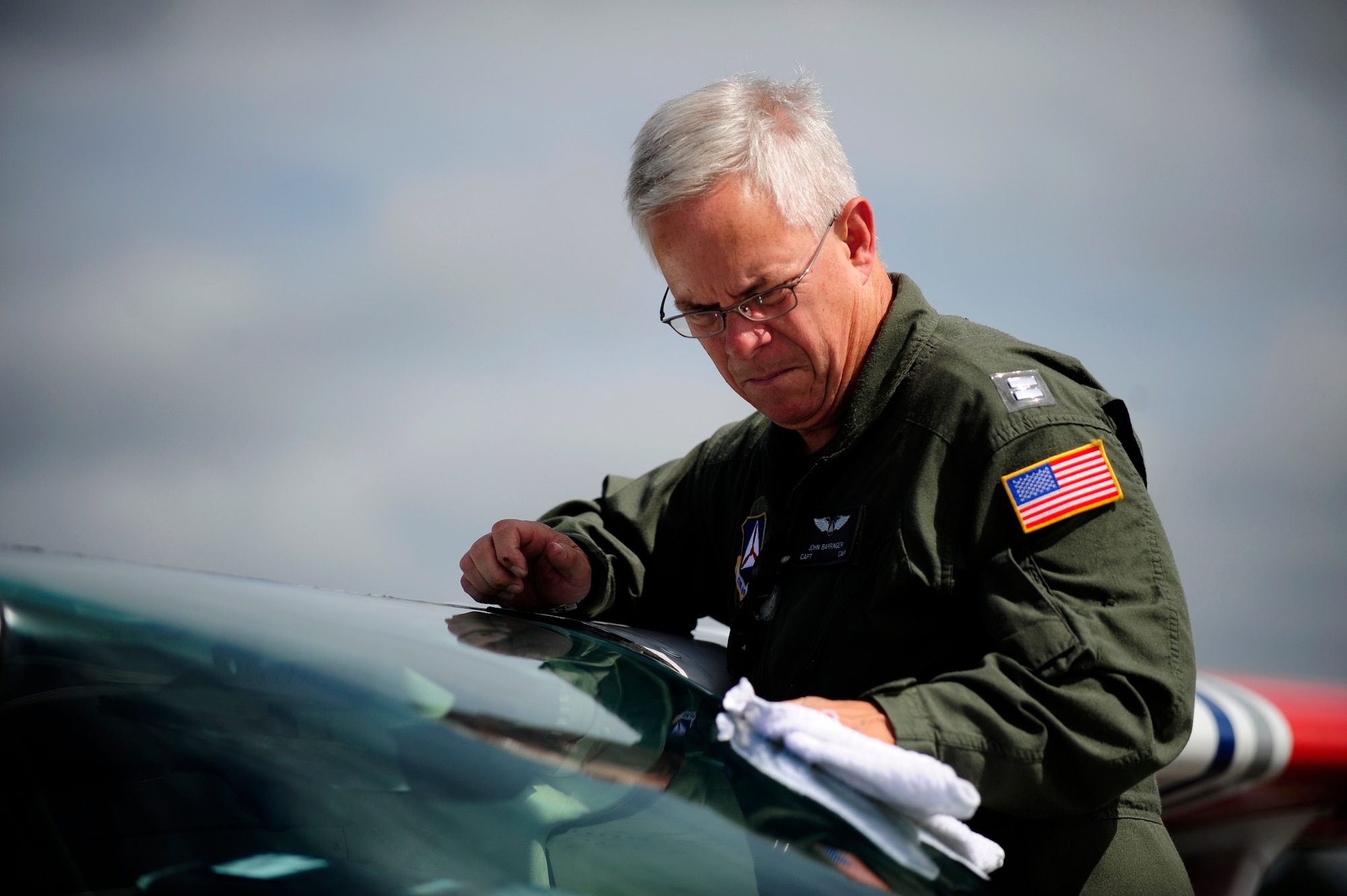 Capt. John Barringer, U.S. Air Force Auxiliary, Civil Air Patrol, cleans the windscreen of a C-182 Cessna before departing Astoria, Ore., during Amalgam Dart 2009, June 18. Amalgam Dart is a field test of the Department of Defense's ability to rapidly deploy a total air integrated defense system in the U.S. in order to deter, detect and defeat airborne threats. (U.S. Air Force photo by Staff Sgt. Jacob N. Bailey)