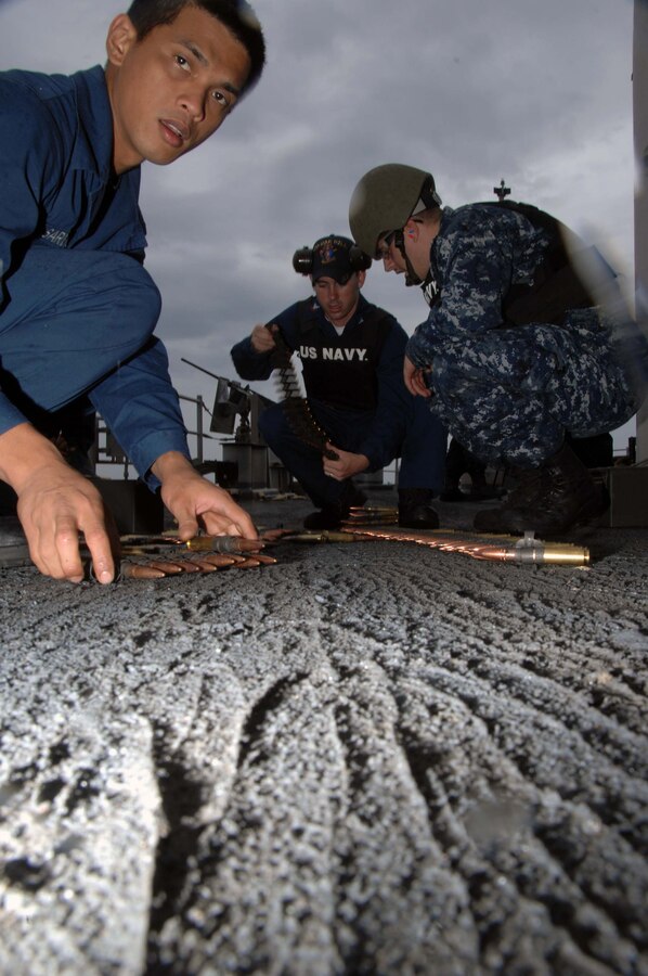 Ship's Serviceman Seaman Rugin Sardon help prepare .50 cal rounds in preparation for firing of .50 cal weapons system during a firing exercise aboard USS Oak Hill (LSD 51) June 23, 2009. The USS Oak Hill is participating in a combined multinational exercise Southern Partnership Station (SPS) '09. SPS '09 is a combined naval and amphibious operation with Oak Hill and maritime forces from Argentina, Brazil, Chile, Peru, and Uruguay. The USS Oak Hill will also support U.S Marine Corps Forces, South multinational combined exercise Southern Exchange 2009 at the Diviso Anfbia and the island of Marambaia, Rio de Janeiro from July 13-31. (U.S Army Photo by Spc. Corey Idleburg/Released)